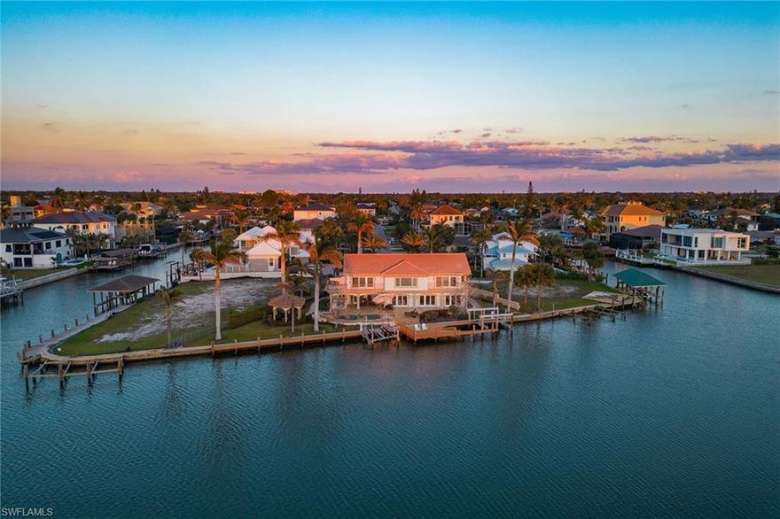 Welcome to 342 Germain Avenue, an unparalleled coastal retreat on an extraordinary gulf access tip lot in the prestigious Conners area of Vanderbilt Beach. This exquisite estate epitomizes the pinnacle of Naples coastal living, offering a unique blend of luxury, privacy and breathtaking waterfront views. At end of Germain Avenue’s cul-de-sac, this premium property spans .37 acres and boasts 175 feet of pristine waterfront with western sunset exposure. Just minutes from the open gulf, Vanderbilt Beach, the Ritz-Carlton Beach Resort, and upscale shops and restaurants at Mercato, this location offers the ultimate in convenience and exclusivity. This is a rare opportunity to customize or rebuild a home tailored to your dreams. The existing two-story architectural masterpiece features a grand entryway with massive iron doors, soaring ceilings and dual curved marble staircases that frame a stunning view of the bay. The house includes five bedrooms and 5.5 baths, with two bedrooms and two full baths on the first floor, along with a pool bath. The expansive kitchen, dining room and living areas offer sweeping water views and are ready for your personal touch. The second floor features a luxurious primary suite with a study and two terraces, one overlooking the water and the other offering extraordinary sunrise views. The second level also features two guest bedrooms, both are en suite with large closets and gorgeous waterfront balconies. One of the most extraordinary features of this home is the vast outdoor space, ideal for grand entertaining or a private oasis. The outdoor kitchen and dining area provide a shady respite, while the resort-style saltwater pool and spa, boat and jet ski lifts, gazebo and deck spanning the entire seawall create the ideal backdrop for relaxation and entertainment. If you are seeking an exclusive boater’s paradise in the heart of Naples, look no further than 342 Germain Avenue. This is coastal living at its finest. Please note the photos depicting the kitchen, dining area and living room are virtual renderings.