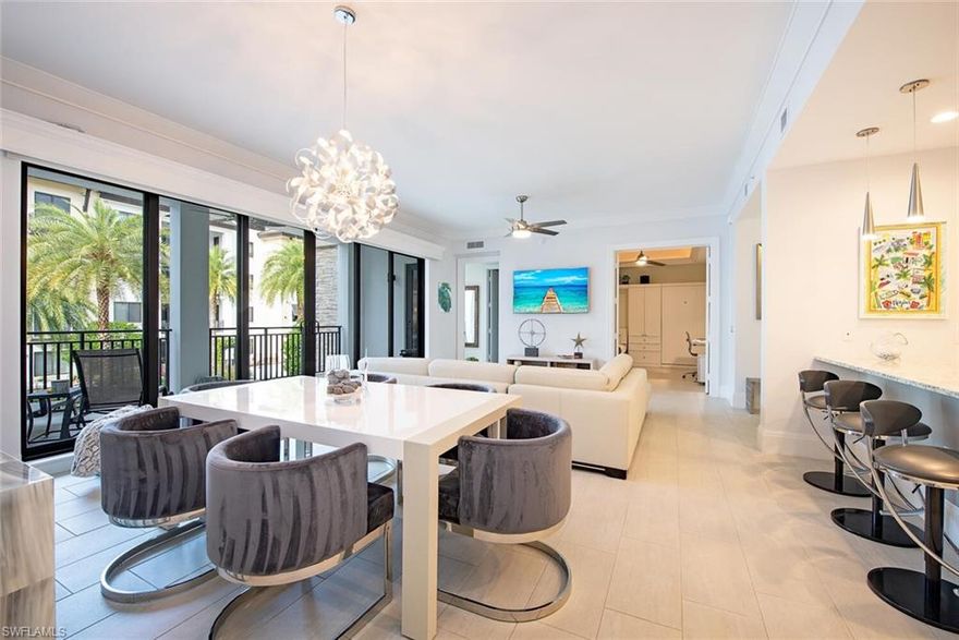 Step into this beautiful, upscale condo in downtown Naples and live the Naples lifestyle you seek just steps off 5th Avenue S with world-class restaurants, upscale shopping, art galleries, car shows and more. This meticulously maintained Naples Square Chelsea floorplan with two bedrooms plus den, two full baths and powder room encompasses 1,832 square feet of luxurious living space. Double doors have been added to the den as well as two twin Murphy Beds to function as a 3rd bedroom when needed. Tile floors throughout except carpeted bedrooms. The great room has motorized shades; all windows and both doors leading to the balcony are hurricane resistant. Enjoy entertaining on your large balcony overlooking the recently upgraded, lush tropical courtyard with pool, spa, firepit, BBQ grills and dining area.   Naples Square residents also enjoy a state-of-the-art fitness center, social room with 3 TVs, billiards and a catering kitchen; under building reserved parking, secure climate-controlled storage and bicycle storage. Walk or bike to Naples pristine white powder sand beach, Baker Park and the Naples Greenway. Turnkey furnished with some exclusions and move-in ready. 2 pets permitted.