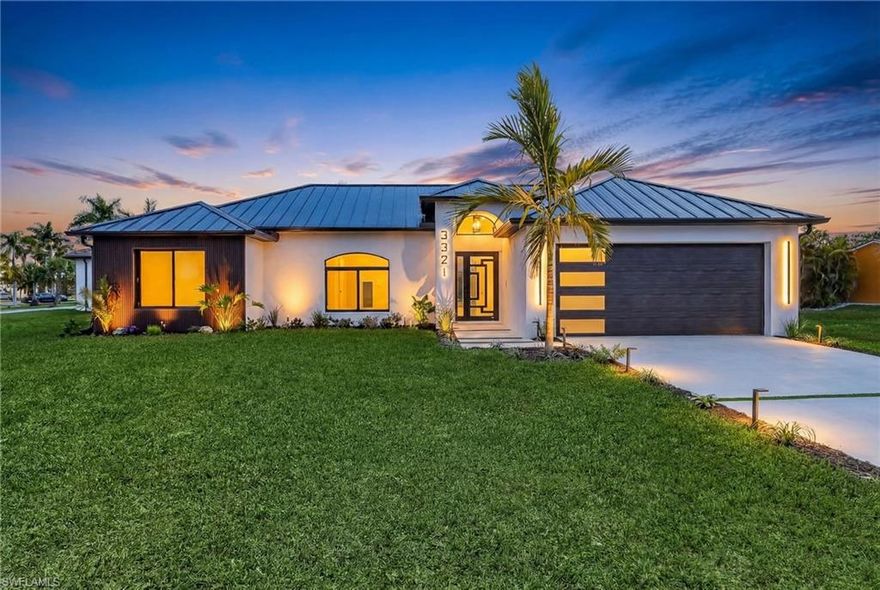 Welcome to your Oasis! This amazing Gulf Access Pool home is located in the coveted Surfside area surrounded by million dollar homes. This home is located on a massive oversized corner lot on one of the widest gulf access canals in Cape Coral. Showcasing the look, feel, and quality of new construction, this impeccable transformed home features a brand new 2026 Standing Seam Metal Roof, Brand new Hurricane Impact windows, doors, and sliders with Low E Argon, a brand new Hurricane Impact Garage door, new Hot water heater, new Irrigation, and a Brand new A/C Unit. On the exterior you’ll notice a new high-end impact resistant garage door, beautiful new  Tropical Landscaping with ambient LED illuminated lighting, new stucco and brand new high quality paint. As you enter inside, you are greeted with a modern and well designed  foyer with incredible finishes. As you walk inside you’ll notice long wood plank tile throughout, modern LED lighting and fans all throughout with brand new recessed lighting. As you enter the kitchen you’ll be amazed by brand new custom modern cabinetry including LED lighting and soft close doors with luxurious Taj Mahal waterfall countertops and Brand New Samsung Bespoke Appliances. The bathrooms are both brand new, breathtaking and thoughtfully designed with a freestanding soaking tub, double vanities and high-end smart toilets with heated seats and night lighting. Step through the impact sliders to an entertainer’s dream lanai showcasing new composite ceiling paneling, a large modern fan, paver pool deck, fully resurfaced pool with new tile, LED lighting, updated drainage, and new pool equipment, all enclosed within a beautifully lit pool cage. A brand new 27-foot wraparound dock by Williamson Brothers is being completed prior to closing, offering quick boating access with only a 30-minute ride to open water. In the garage you'll notice a new epoxy garage floor, new lighting and paint. Whether you are searching for the perfect family waterfront retreat, luxury seasonal escape, or high-performing Airbnb/vacation rental, this exceptional property offers location, lifestyle, and luxury all in one — schedule your private showing today before this rare opportunity is gone.