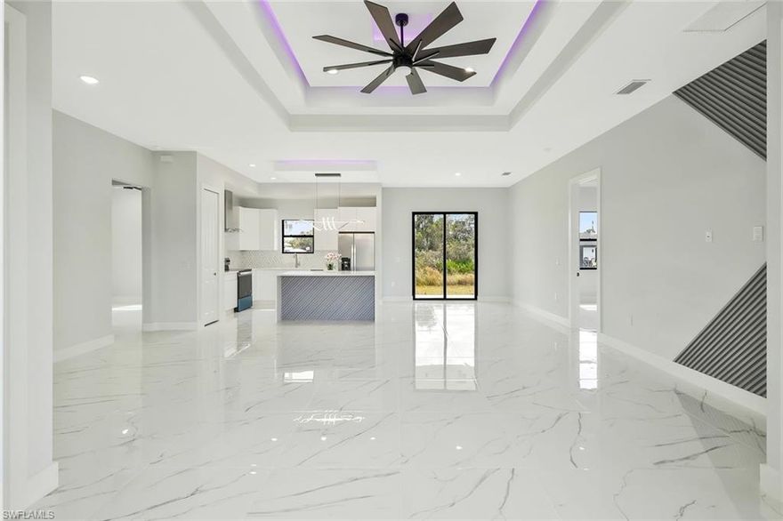 Welcome to this stunning newly built single-family home located in the highly desirable northwest area of Lehigh Acres. Offering 4 spacious bedrooms, 2 full bathrooms, and 1,715 sq. ft. of living area (2,296total sq. ft.)
From the moment you enter, you’ll be impressed by the expansive open-concept layout, oversized porcelain tile throughout, and stunning tray ceilings with LED accent lighting that create a sophisticated, high-end ambiance. The living area is anchored by a dramatic modern ceiling fan and flows seamlessly into the chef-inspired kitchen.
The kitchen features a large waterfall-style island, sleek cabinetry, stainless steel appliances, and modern pendant lighting perfect for entertaining.The bathrooms showcase floor-to-ceiling marble style tile, frameless glass shower enclosure, dual vanities with quartz countertops, and contemporary fixtures offering a true spa-like experience. Additional highlights include impact-resistant windows and doors, central electric HVAC, ceiling fans, water treatment system, auto sprinkler system, and a 2-car attached garage with paved driveway.
Situated on a generous 0.25-acre lot, this property features well water and septic, and no HOA fees providing flexibility and freedom for homeowners. Seller offer $10,000 toward buyer closing costs with full price offer.