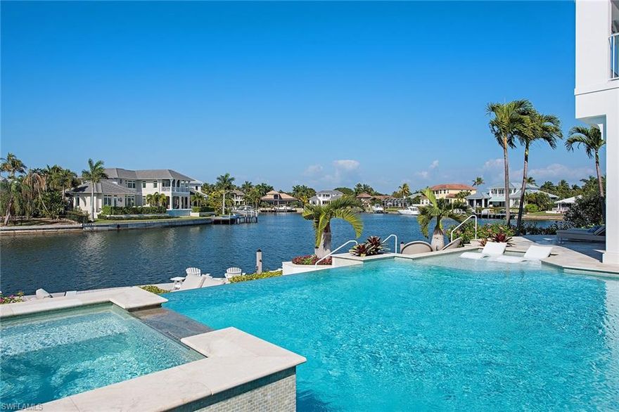 Encompassing over 5,300 square feet of living area with an open, great room plan, this two-story home offers Park Shore living at its finest! Crisp, clean finishes include European wide plank oak flooring throughout, custom moldings and 9-foot folding glass walls. The first-floor master suite features dual closets, a generous bath area with soaking tub and French doors for easy lanai access. The gourmet kitchen features a butler’s pantry, double island, custom shaker cabinetry, gas cooking and top-notch appliances. The second level, accessible by stairs or elevator, has a wonderful living area with a wet bar/beverage station, three guest suites with full baths and walk-in closets and generous covered balcony and sitting area. With over 100 feet of water frontage overlooking Venetian Bay, the outdoor space offers a dock, cozy fire pit, negative edge pool with sun shelf, ample seating areas and a well-appointed kitchen. The three-car garage is enclosed with a mahogany reinforced door and has ample storage. Venetian Village is moments away for dining and shopping or enjoy sunsets at the private Park Shore beach access.