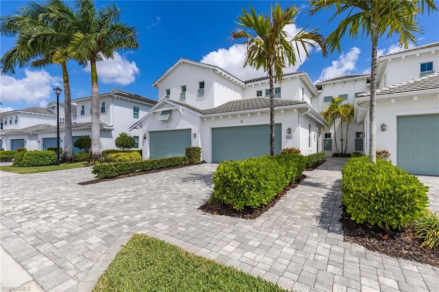 Experience elevated coastal living in this impeccably designed, furnished second-floor coach residence, set in one of Naples sought-after Toll Brothers communities, known for quality construction and cohesive architectural design. The home lives with the ease and scale of a single-family residence with soaring ceilings, an open layout, and walls of impact glass framing long lake and fountain views. Wood-look tile runs throughout the main living areas, complemented by tray ceilings, crown molding, plantation shutters and refined lighting. The kitchen is a design focal point and functional, featuring a large natural gas cooktop, dual wall ovens, quartz surfaces, shaker-style cabinetry, stainless appliances and a substantial island. Upgraded refrigerator makes jumbo ice spheres to chill your favorite beverage. Slide-out pantry shelving and soft-close pot drawers enhance everyday usability, while a custom bar with wine storage supports effortless entertaining. Living and dining areas extend to the screened lanai with serene water views. The primary suite offers a sense of quiet separation and refined comfort, with two walk-in closets with custom built-ins. The bath features a walk-in shower with upgraded drain, soaking tub, and extended dual vanity with added storage. Guest bedrooms are positioned as private quarters, ideal for visitors, while a flexible den offers workspace or retreat. Natural light is abundant with volume ceilings and upgraded lighting and fans. Exceptional storage, rare for Naples, with custom closets, additional interior storage and a spacious two-car garage set this residence apart. Additional features include a tankless water heater and full-impact windows and doors. This is currently the only available four-bedroom residence (third bedroom with closet shown as den) in Azure, offering over 2,600 square feet of living space, an uncommon combination of size, layout and lakefront setting. Residents enjoy a staffed guardhouse and secondary automated entry, along with resort-style amenities including tennis, pickleball, beach-entry pool and spa, fitness center and clubhouse with social spaces. Conveniently near dining, shopping, Interstate 75, and Naples and Marco Island beaches.