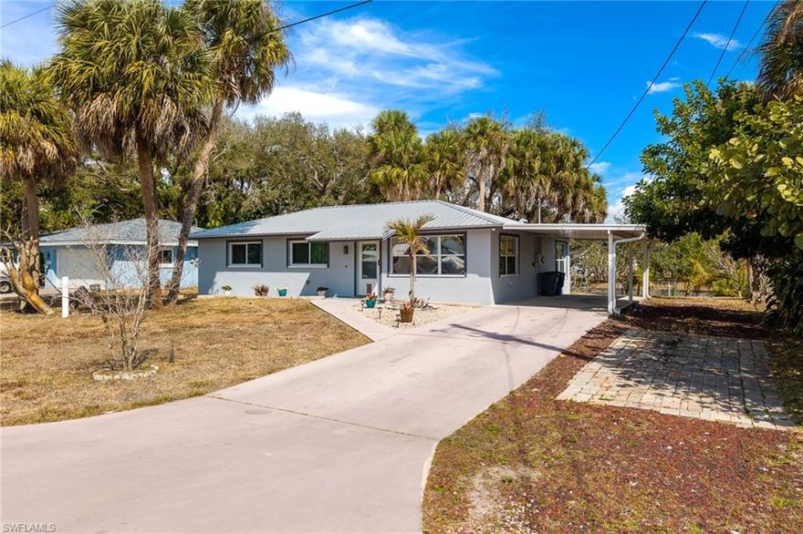 Welcome to this beautifully maintained waterfront retreat in North Fort Myers, offering direct boating access to the Caloosahatchee River and the Gulf of America from your own backyard. Situated on a freshwater canal, this 3-bedroom, 2-bathroom home features 1,191 square feet under air, a 1-car attached garage, and an expansive screened-in back porch designed to take full advantage of Florida’s indoor-outdoor lifestyle.

Originally built in 1973, the home has been tastefully updated and meticulously cared for, blending classic Florida charm with modern improvements. A durable metal roof was installed in 2021, and at the same time most of the home’s windows were replaced with impact-resistant windows, providing added storm protection, energy efficiency, and peace of mind. Electrical components were also updated in 2025.

Inside, you'll find a bright open-concept living and kitchen area with recessed lighting, updated cabinetry, stainless steel appliances, and attractive wood-style flooring that flows through much of the home. The spacious living room connects seamlessly to the kitchen and dining area, creating an ideal layout for entertaining or relaxing after a day on the water. Large windows throughout the home allow natural light to fill the space while offering peaceful views of the canal and mature tropical landscaping.

The primary bedroom offers comfortable space and privacy, while two additional bedrooms provide flexibility for guests, family, or a home office. Enjoy the large, dedicated laundry room, which provides additional storage and functionality.

Step outside to the large screened lanai overlooking the canal, a perfect spot for morning coffee, evening cocktails, or entertaining friends and family. The backyard features mature palms and shade trees, a concrete seawall, and a concrete dock, making it easy to launch a kayak, fish from your backyard, or take your boat out for a day on the river.

This property is being sold fully furnished and turnkey and is currently operating as a successful Airbnb, making it an excellent opportunity for investors, seasonal residents, or anyone seeking a ready-to-enjoy Florida waterfront getaway.

Conveniently located near shopping, dining, golf courses, and just a short drive to downtown Fort Myers, this home offers the perfect combination of waterfront living, income potential, and move-in-ready comfort. Come experience the relaxed Southwest Florida lifestyle this canal-front property has to offer.
