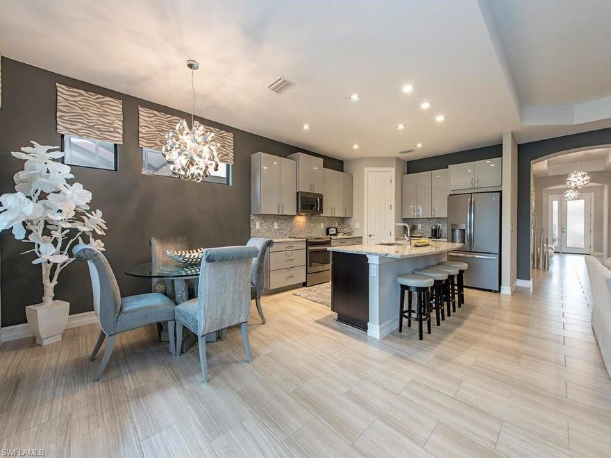 H.11451 - Completely upgraded Ashbury floor plan on the BEST lakefront lot in this brand new community in the heart of Naples: close to shops, restaurants, and schools! This gracious home is a show stopper with designer kitchen cabinets above and far beyond what the builder offers with gleaming granite countertops, premium fixtures, GE appliances, designer light fixtures, extended lanai with a beautiful heated saltwater pool and spa all overlooking the lake and fountain. The lanai provides an ample shaded area and plenty of poolside lounging space for relaxing and entertaining. The oversized lake lot is the ideal location in Tuscany Pointe. This home is truly a must-see. All of the work of upgrading and finishing off a new build has been done. Want a summer kitchen? Plumbing and electric are there to complete as you desire. See remarks for showings.