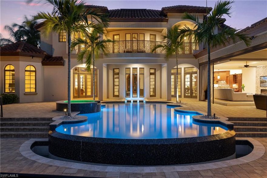 Welcome to the luxurious Escada Estates in Tiburon! Enjoy picturesque pool and lake views from just about every room of this custom-built estate. An open floor plan surrounds the breathtaking infinity edge pool and spa. Gourmet kitchen with gas Wolf range, SubZero refrigerator and an excess of cabinetry and counters. Exposed butler's pantry with espresso station. Living room features cozy fireplace and pocket sliding doors offering premier indoor/outdoor living. Spacious main floor master bedroom with pool access. Attached workout area, coffee bar and his and her walk-in closets. Master bath with large walk-in shower and tub. Additional bedroom with ensuite and executive office with full bath on the main floor. Spiral staircase leads you upstairs to the family room. 3 additional bedrooms all with bath and balcony access. Sprawling backyard beyond the fenced in lanai. 3 car garage. Quiet cul-de-sac. The neighboring Ritz Carlton Golf Resort offers 5 Star amenities including two 18-hole courses designed by Greg Norman at Tiburón Golf Club, Reservoir Waterpark, spa and dining cuisines for every occasion. Easy access to I-75 and minutes to world class beaches, shopping and fine dining.