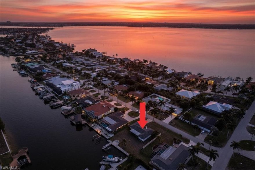 Boater’s paradise! Intersecting Canal Views! Enjoy Direct Sailboat Gulf Access just minutes to the river. Positioned to look straight down a wide intersecting canal and across the expansive 200+ foot Bayshore & Coral canals, this property delivers true million-dollar water views in one of Cape Coral’s most sought-after boating neighborhoods. Located on iconic Bayshore Drive, known for deep water access and multi-million dollar waterfront estates, this residence sits just a short bike ride from Cape Coral’s only beach and the revitalized Yacht Club district. Sailboat access places you nearly 2  minutes to the Caloosahatchee River and open water with no bridges and no locks, making this a true boater’s paradise.  This beautifully remodeled two-bedroom, two-bathroom coastal cottage is offered fully furnished and move-in ready. The open floor plan is filled with natural light and designed to capture panoramic canal views from the main living areas. The stylish kitchen features modern appliances and ample storage, while the spacious primary suite offers abundant light and access to the screened lanai. The second bedroom is ideal for guests or a home office.

Outdoor living is where this property shines. The expansive screened lanai provides the perfect setting for waterfront dining, sunset cocktails, fishing, or simply soaking in the ocean breeze. A private dock with a boat lift allows you to launch directly from your backyard and enjoy world-class boating, fishing, waterfront restaurants, white sand beaches, and the barrier islands of Sanibel and Captiva.

Location is everything, and this home sits within a five-mile radius of Cape Coral’s most ambitious waterfront developments. Nearby destinations include Slipaway Marina with waterfront dining, food trucks, and live entertainment; The Cove at 47th, South Cape’s emerging downtown district featuring boutique shops and top rated restaurants; Bimini Square with waterfront dining, marina access, and Lee Health medical services; and the transformative 300 million dollar Yacht Club Beach and Marina redevelopment bringing new pools, dining, recreation, and long term growth to the area.

Whether you are searching for a winter retreat or a future site to build your dream home, there is no better value offering these views, this boating access, and this location in the highly desirable Yacht Club. This is Southwest Florida waterfront living at its finest.