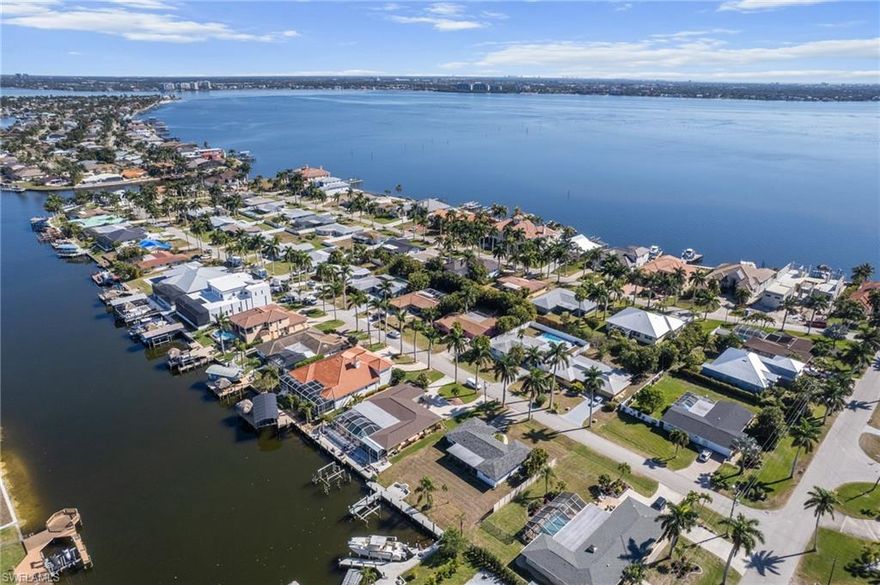 Boater’s paradise! Intersecting Canal Views! Enjoy Direct Sailboat Gulf Access just minutes to the river. Positioned to look straight down a wide intersecting canal and across the expansive 200+ foot Bayshore & Coral canals, this property delivers true million-dollar water views in one of Cape Coral’s most sought-after boating neighborhoods. Located on iconic Bayshore Drive, known for deep water access and multi-million dollar waterfront estates, this residence sits just a short bike ride from Cape Coral’s only beach and the revitalized Yacht Club district. Sailboat access places you nearly 2  minutes to the Caloosahatchee River and open water with no bridges and no locks, making this a true boater’s paradise.  This beautifully remodeled two-bedroom, two-bathroom coastal cottage is offered fully furnished and move-in ready. The open floor plan is filled with natural light and designed to capture panoramic canal views from the main living areas. The stylish kitchen features modern appliances and ample storage, while the spacious primary suite offers abundant light and access to the screened lanai. The second bedroom is ideal for guests or a home office.

Outdoor living is where this property shines. The expansive screened lanai provides the perfect setting for waterfront dining, sunset cocktails, fishing, or simply soaking in the ocean breeze. A private dock with a boat lift allows you to launch directly from your backyard and enjoy world-class boating, fishing, waterfront restaurants, white sand beaches, and the barrier islands of Sanibel and Captiva.

Location is everything, and this home sits within a five-mile radius of Cape Coral’s most ambitious waterfront developments. Nearby destinations include Slipaway Marina with waterfront dining, food trucks, and live entertainment; The Cove at 47th, South Cape’s emerging downtown district featuring boutique shops and top rated restaurants; Bimini Square with waterfront dining, marina access, and Lee Health medical services; and the transformative 300 million dollar Yacht Club Beach and Marina redevelopment bringing new pools, dining, recreation, and long term growth to the area.

Whether you are searching for a winter retreat or a future site to build your dream home, there is no better value offering these views, this boating access, and this location in the highly desirable Yacht Club. This is Southwest Florida waterfront living at its finest.