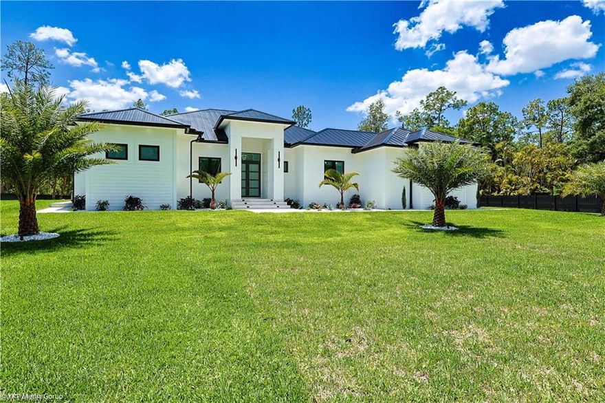 . 100% uplands. This exquisite new-construction residence offers the perfect fusion of sophistication, comfort, and smart design. The home welcomes you with a spacious paver driveway, electric gate, and full perimeter fencing, providing both privacy and curb appeal enhanced by upgraded landscaping and a full irrigation system. Inside, every detail has been thoughtfully curated from the custom designer ceilings with led lighting . The designer kitchen features custom cabinetry and thermador appliance package, all complemented by upgraded exotic quartzite countertops with a waterfall island edge and elegant floating bathroom vanities . Luxury continues throughout with  porcelain-tiled bathrooms floor-to-ceiling, and lighted mirrors in every bath. The home is truly built for refined living and entertaining, offering a fully wrapped granite outdoor kitchen with stainless steel  gas cooktop, sink ,  under-counter refrigerators, and ample cabinetry for effortless hosting. Step outside to your private resort-style pool and spa, picture-window screen enclosure, and lush tropical landscaping that enhances privacy, while the insulated garage doors and epoxy floors. This home  meticulous attention to detail. Blending modern innovation, high-end finishes, and timeless design, this home delivers a rare level of luxury and craftsmanship inside and out. Combines the freedom of acreage with the convenience of city living: • Near top-rated schools • Minutes to shopping & dining • Quick access to I-75 • Close to beaches, including Vanderbilt Beach • Located in a high-value growth corridor Homes with acreage this close to Naples are rare —