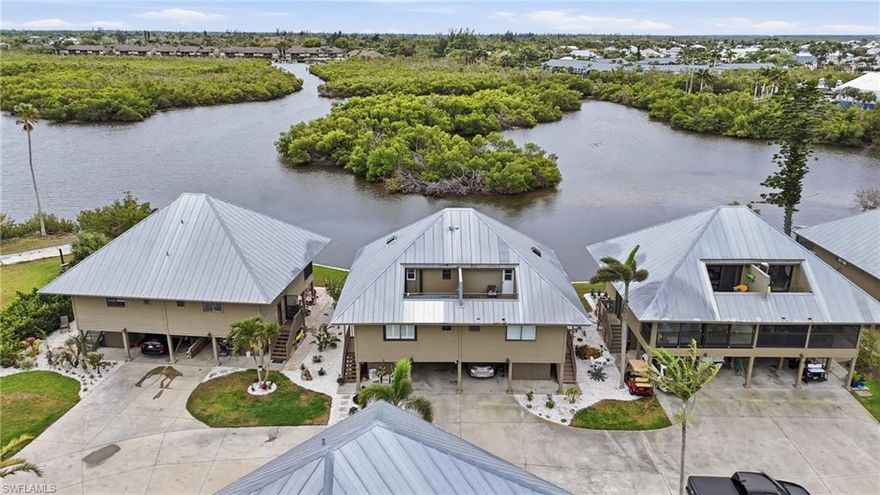 Boat, fish, and live the island lifestyle—right from your own backyard.

If you’ve been dreaming about keeping your boat just steps from your door and being on the open waters of Charlotte Harbor within minutes, this is the one.

Tucked away at the quiet north end of Pine Island in Bokeelia, Marina Gardens is a hidden gem with only 17 residences, surrounded by water and immersed in the natural beauty that makes island living so special.

This beautifully updated waterfront condo is truly move-in ready and offers peace of mind with numerous recent upgrades, including hurricane shutters, a completely updated screened lanai with new frame, flooring and screens, resurfaced and waterproofed balconies, new patio, skylight, water heater, and more.

But what truly sets this property apart is the boating and fishing lifestyle.

Step outside to your private dock with a 10,000 lb boat lift, complete with water and electric, and you’re just minutes from some of the best fishing in Southwest Florida. Cruise effortlessly to Charlotte Harbor, explore the peaceful backwaters of Jug Creek, or stop by Four Winds Marina for fuel and supplies. You can even dock and dine at Jug Creek Marina and Fish House—a true local favorite.

Every day here feels like a retreat. Watch dolphins and manatees glide by, see ospreys and pelicans overhead, and take in the peaceful mangrove views from your upstairs balcony, screened lanai, or patio below.

Marina Gardens residents also enjoy a beautifully maintained community pool with high-end furnishings and well-kept facilities—perfect for relaxing after a day on the water. The community is also scheduled for fresh exterior paint in a beautiful coastal blue in the coming year, adding to its charm and curb appeal.

The HOA provides exceptional value by covering pool and pool house, flood insurance, exterior maintenance, seawall, docks, ramps, septic, landscaping, and street maintenance, making this an easy, low-maintenance way to enjoy waterfront living.

If you’ve been searching for a place where you can truly embrace the Southwest Florida waterfront lifestyle—this is it.