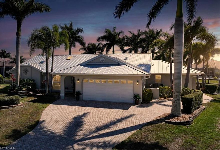 Welcome to the highly sought after community of Punta Gorda Isles!  This 3 bed 2 1/2 bath waterfront pool home features a stunning 182 feet of water frontage, breathtaking wide water views, and an outdoor lifestyle designed to impress. From the moment you enter, you’ll love the light-filled living room with vaulted ceilings and stunning canal views.  There are two spacious living areas plus a formal dining room with a custom dry bar, all perfect for entertaining.  The well appointed kitchen has stainless steel appliances, granite countertops, a built-in coffee system, and a pass-through window to the lanai - seamlessly connecting indoor and outdoor living. The primary suite has a large bedroom with a tray ceiling, private lanai access, an expansive walk in closet, and leads to your en suite bathroom. The bath features dual sinks, a walk in shower, and a separate soaking tub. A thoughtfully designed split floor plan includes a guest wing with pocket door for added privacy. Both guest bedrooms are large in size and there is a full bath with a walk in shower and convenient pool access. There is also a half bathroom. The interior laundry room has a laundry tub and added storage. Step on out to the pavered lanai and an extraordinary outdoor living experience plus an outdoor lounge patio. The heated saltwater pool showcases a water feature and variable speed pump, while the hot tub conveys with the home. The Viking outdoor kitchen elevates alfresco entertaining, all set against an expansive, panoramic water view with desirable southern exposure. Enjoy boating? You are only steps away from your THREE concrete docks & a 25,000lb boat lift with quick power boat access out to Charlotte Harbor and beyond to the open waters of the Gulf. With a jet ski lift, kayak rack, and fish cleaning station, you have a true waterfront playground right in your backyard. Other features include:  newer standing seam metal roof, gutters, impact skylights, impact windows, PEX piping, tile flooring throughout, plantation shutters, hurricane screens on the lanai, and an epoxy-finished garage floor with added shelving for optimal storage. This home is conveniently located to Fishermen's Village, downtown Punta Gorda, shopping, dining, medical, entertainment, and so much more.
