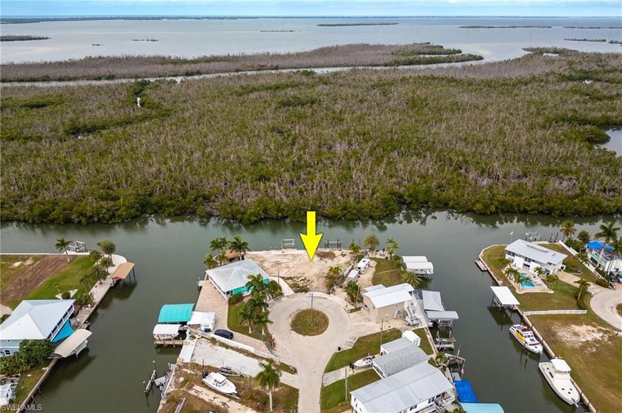 Welcome to Your Waterfront Paradise!!

Discover a rare and extraordinary opportunity in this exclusive island boating community: two contiguous, buildable lots offering an expansive canvas for your coastal vision. Framed by peaceful canals, this double lot boasts direct, bridge-free access to the Gulf, making it an ideal haven for avid boaters and water lovers alike.

Property Highlights:

Prime Waterfront Orientation: This large cleared parcel provides generous water frontage and the flexibility to design a grand single residence or twin waterfront homes.

Deep Water Canal: The calm, navigable canal affords direct access to the Gulf, allowing seamless boating from your own backyard — no bridges, no compromise.

Dock Potential: Room to create an extraordinary waterfront dream, with an expansive private dock or multiple boat lifts, giving you immediate access for your boat, jet ski, or water toys. Existing pilings with slip accommodate a large boat.

Island Community Lifestyle: Located in a serene, maritime island enclave where every neighbor is a fellow boater. Enjoy the charm of private island living with all the amenities that come with it: waterfront restaurants, boating social opportunities, world class fishing, and peaceful, salt-kissed breezes.

Ready for Your Build: Cleared and mostly level, the lot is primed for construction. Whether you're dreaming of a custom home, a waterfront compound, or a seasonal retreat, this property offers unmatched flexibility.

Natural Beauty: Lush mangroves line the canal, offering privacy and a great view of wildlife. At sunrise and sunset, the water glows with a golden hue — a daily reminder of the tranquil island life you're investing in.

Excellent Investment: Waterfront real estate with direct Gulf access is increasingly rare — this double-lot parcel represents not just a home site, but a high-value long-term asset.

Location Perks:

Minutes from Pine Island Sound, so you can cruise into open Gulf waters with ease to the nearby beaches of Sanibel, Fort Myers Beach, and Captiva Island.

Easy access to local community essentials while still living in the laid-back, saltwater rhythm of an island lifestyle.