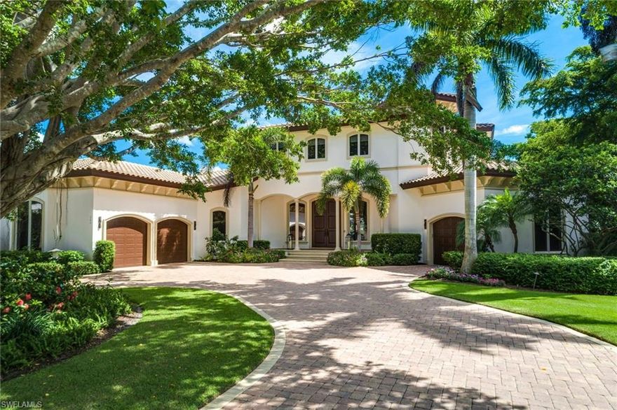 H.13504 WATERFRONT elegance on stately Spring Line Drive.  Located near the western end of a quiet cul de sac, this timeless two-story estate showcases long & private views across Compass Cove. Perfectly situated to take advantage of coastal breezes & water views from nearly every room. Gorgeous outdoor entertaining, w/ infinity pool & spa, & spacious covered lanai where you can relax & enjoy watching dolphins pass by.  Private park-like feel with an expansive lawn, mature trees & a picturesque butterfly garden. Inside, the thoughtfully designed floor plan is open & light, perfect for today’s entertaining lifestyle, but also provides separate living spaces & privacy.  Main level includes a living room w/fireplace, grand chef’s kitchen with gas cook-top, family room, study, & alluring master suite.  Upstairs is a second living area w/large waterfront balcony, & 3 additional bedrooms, all with en-suite baths.  Other features include upstairs/downstairs laundry, upstairs bar & multiple storage closets. Best of all, there is a private boat dock & lift w/Gulf access through nearby Doctor’s Pass.  Private beach access available at the Moorings Residents Beach Park, a short walk away.