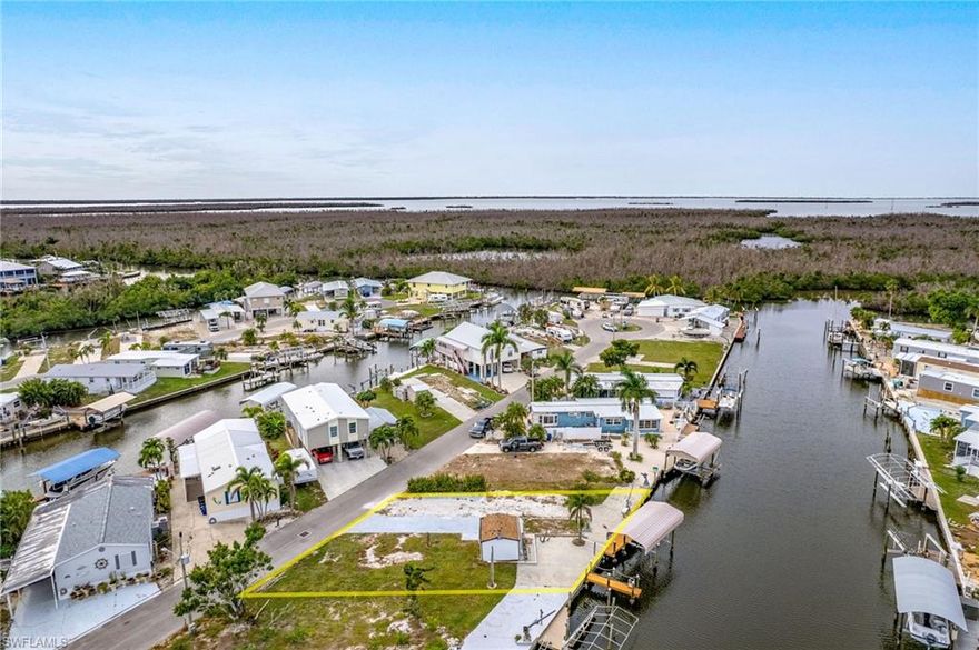 One and a half lots combine to give you options for a new home with 75' of Water-Frontage! There is an 8,000 lb. COVERED Boat-Lift in place, 2 Docks, AND Davits as well! This property is on sewer, giving you even more buildable space than surrounding properties. There is a shed on-site already. The owner was in the process of placing a new manufactured home on the property, gaining you site work, Including a new Electric Service Box, and more. The savings add up quickly with the Impact fee waived on a new manufactured (and only the difference due between manufactured and Single Family). There is even a permit for a new manufactured home that you could capitalize on by submitting your home plans to Lee County. The opportunity to spread out and live the "Island Life" is waiting...