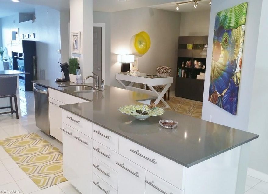 Remodeled from top to bottom, this first floor Spanish Wells condo is absolutely stunning! It looks like it could be an Architectural Digest award winner! Featuring an open kitchen and dining area, one will appreciate the light and airy atmosphere. The morning sun and afternoon shade on the Lanai compliments a fantastic view of the long lake. The large master bedroom with walk-in closet has a gorgeous bath, which will make you feel right at home! The guest bedroom offers twin beds and a delightful shower bath. The updated decor is perfect for entertaining friends and family. The community pool is across the street on the cul-de-sac, the live oaks, central location and great neighbors creates a wonderful lifestyle! The garage is the second from the west end. Picture over living room sofa and china do not convey.