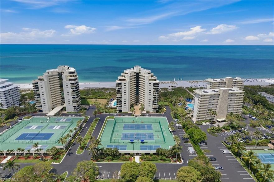 Experience beachfront living on Marco Island from this light-filled residence in Sandcastle at Marco Beach, offered turnkey and furnished for immediate enjoyment, where sweeping Gulf views and direct beach access create an exceptional coastal lifestyle. This two-bedroom, two-bath condominium with one garage space features a desirable split-bedroom floor plan, impact windows and an open layout designed to maximize natural light and indoor-outdoor living. The interior offers a bright, neutral palette complemented by crown molding and tile flooring set on the diagonal throughout the main living areas. Large sliding glass doors span the living space, inviting in abundant natural light while seamlessly connecting to the expansive lanai. The open and airy living room is ideal for relaxing and entertaining, flowing comfortably into the adjacent dining area, which features a hanging light fixture and easy kitchen access. The kitchen is well-appointed with GE stainless steel appliances, including a range, microwave and dishwasher, along with an LG French door refrigerator, tile backsplash and a convenient two-seat breakfast bar for casual dining. Designed for functionality and style, the space offers everything needed for everyday living or hosting guests. The spacious primary suite serves as a private retreat, highlighted by large sliding glass doors that open to the lanai, providing a dedicated outdoor seating area with stunning Gulf views. Crown molding and a generous walk-in closet enhance the space, while the en-suite bath features a large vanity, walk-in shower and private water closet. The guest bedroom is equally inviting, offering Gulf views, crown molding, abundant natural light and access to the lanai, with a full guest bath conveniently nearby. The split-bedroom design ensures comfort and privacy for residents and visitors alike. Outdoor living is a true highlight, with a spacious open lanai that runs the full length of the residence, providing multiple seating areas to take in the incredible beach and Gulf views. Whether enjoying morning coffee or evening sunsets, this expansive outdoor space captures the essence of Marco Island living. Sandcastle at Marco Beach offers a premier beachfront location with easy access to the island’s renowned white sand beaches, nearby dining and shopping, making this an exceptional opportunity to enjoy the best of Southwest Florida coastal living.