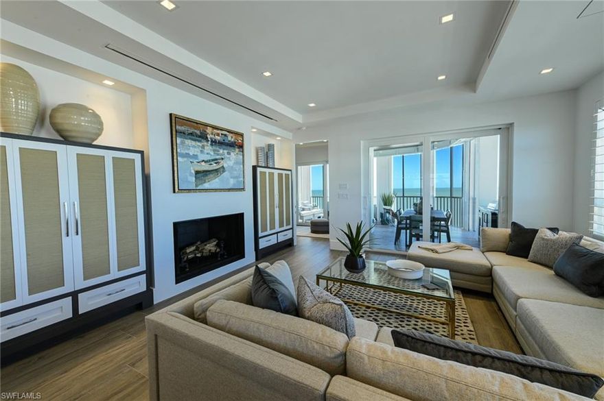 This Barefoot Beach end unit Penthouse offers the ultimate in luxury Florida beachfront lifestyle and is perhaps the finest condominium in the Barefoot Beach Club. This condo was taken to the bare concrete walls and totally reimagined to a timeless design where it is unrecognizable from the original floor plan. Enter via the custom lighted entry into immediate Gulf views via its open floor plan where the kitchen opens to the dining area & living room and they are all open to the screened lanai on the beach. The lanai offers outdoor dining, large seating area and a summer kitchen with grille all overlooking the turquoise water and white sand beach. There is a custom built sitting area offering hidden door access to the laundry room. The added half bath also is sleekly set into the wall with custom art camouflaging its location. The kitchen features a large island with cascading top, high end appliances, custom cabinetry, panoramic preserve & bayside views with amazing sunrises to the east, and wide Gulf views and sunsets to the west.  The living area highlights the penthouses already taller ceiling heights which have been maximized with low profile linear HVAC ducts & led spot lighting. There is both a large screen HDTV & in ceiling theater projection for movie night. There are custom ceiling and millwork details throughout including the outdoor lanai’s custom tongue & groove ceiling & wood design electric shutter boxes that bring the indoor quality outdoors. The master bedroom layout has been vastly improved with bed wall facing the Gulf. The master bath is stunning with his & her vanities, hidden storage, beautiful soaking tub, & walk in shower. The master bedroom closet is finished with custom cabinet quality. The two guest bedrooms with en-suite baths are finished to the same level as the master bedroom and bath. Other features include: fireplace, solid wood 8’ doors, 4” ceiling lights including the lanai ceiling, designer light fixtures & plumbing fixtures, wood plank tile flooring throughout, custom built-ins inc the open den area shelving, Impact windows & sliding doors. Best of all the Interior design furniture and furnishings are available for purchase for a quick seamless move in.  Barefoot Beach is Collier County’s premier gated Beach to Bay community featuring Royal Palm lined brick paver streets, 2 security guards 24 hours, and no public parking within the community. Barefoot Beach Club is a well managed & maintained family friendly Condominium Association. Gulf access boat dock leasing options are available. Option to join the Club at Barefoot Beach (located in the community) which offers casual & fine dining restaurants, pool & beachside food, drinks, chair service, indoor & outdoor bars, ice cream & coffee shop, tennis courts with pro & a full events calendar. (waitlist with usage during wait period). Barefoot Beach is centrally located to dining, entertainment, golfing, arenas & is close RSW Airport, the Promenade & Coconut Point.