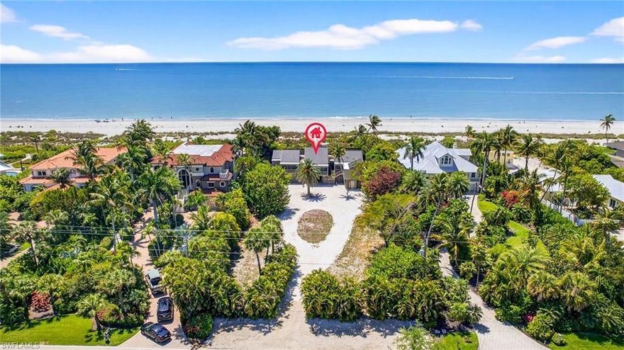 Experience the essence of true island living along prestigious West Gulf Drive. This fully reimagined and elevated Gulf-front residence, originally designed by renowned architect Charles Harrison Pawley, reflects a timeless coastal philosophy rooted in environmental responsiveness by featuring open planning, natural cross-ventilation for coastal comfort, and the thoughtful use of native materials that blend design with the textures, light, and character of its Gulf-front setting.
Set on a private acre with sweeping views of the Gulf of Mexico, the home offers direct beach access via a private dune walkover inviting daily shelling, tranquil morning walks, and breathtaking sunsets just steps from your lanai. Wake each morning in the primary suite to expansive beach views, where the sound of waves and soft sea breezes create a true sense of retreat.
Designed for effortless indoor-outdoor living, the spacious living and dining areas flow seamlessly to a grand screened lanai. Here, a thoughtfully positioned spa invites you to unwind beneath glowing sunset skies, where coastal breezes, gentle surf, and sightings of shorebirds and dolphins become part of everyday life.
Inside, vaulted tongue-and-groove ceilings with exposed beams create warmth and architectural character, complemented by a calm, neutral palette, elegant, tiled baths, and a well-appointed kitchen with granite surfaces and premium appliances. Karastan luxury vinyl plank flooring runs throughout the home, while the lanai and surrounding balconies feature rich cedar decking echoed by the home’s classic cedar board-and-batten exterior.
Arrive along a graceful circular drive framed by lush native landscaping, where swaying palms and coastal foliage create a serene, welcoming approach. A natural shoreline berm enhances both privacy and protection, lending a sense of seclusion and retreat. Below, the ground level offers generous parking, garage access, and a private elevator providing a seamless transition to the elevated living spaces above, where Gulf views and coastal breezes await.
Elevated construction, a new standing seam metal roof, and extensive updates provide lasting resilience and peace of mind. Surrounded by tropical plantings and set along one of Sanibel’s most coveted stretches of coastline, this is Old Florida living as it was meant to be refined, relaxed, and deeply connected to the Gulf.