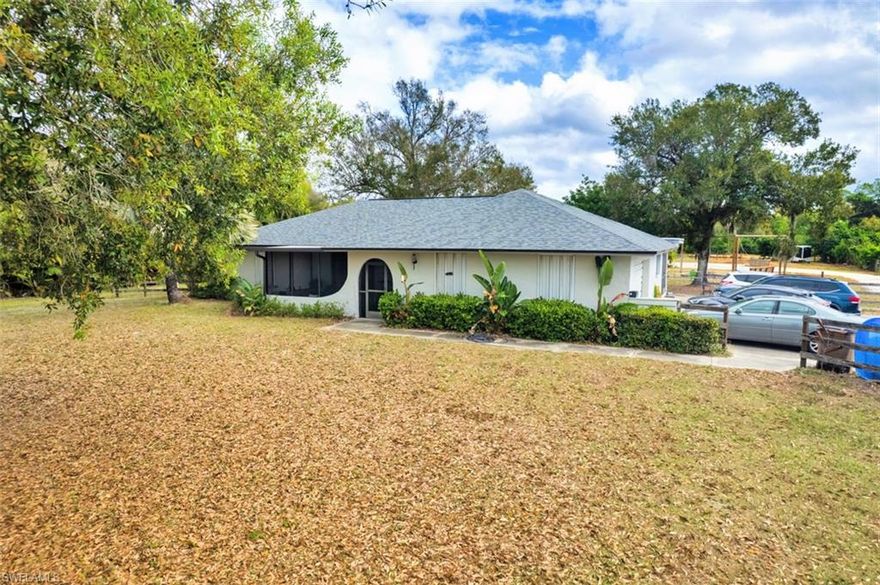 Buckingham country horse farm on just over 5 acres—ready for a new family and a few horses to call it home! This agriculturally-zoned property is fully fenced and cross-fenced with a double-gated entry, offering an ideal setup for horses, livestock, and country living. With an approximate 40’ x 31’ barn/workshop, 4 stalls, covered RV parking, and 5 paddocks with water run to each, this is a fantastic opportunity for anyone looking to create their own working farm or equestrian retreat. This property is thoughtfully set up with electric fencing, and even includes a pig shed, making it ideal for a variety of animals. Located near the Buckingham Trails Preserve, you’ll also enjoy access to great riding paths nearby.
The ranch-style home features 3 bedrooms, 2 bathrooms, a split-bedroom floorplan, and an attached 2-car garage. One of the best features of this home is the incredible indoor/outdoor living space, including large screened front and back lanais plus a covered rear patio. The back patio and lanai are truly the heart of the home—a perfect place to sit with your morning coffee, enjoy evening dinners in Florida’s beautiful weather, and take in peaceful views of your land and animals. Major updates have already been completed including a roof (2017) and A/C (2020), along with designer paint, a newly remodeled kitchen, and a graveled extended driveway.
This property offers excellent functionality with two wells—one dedicated to the home and one for livestock, helping support efficient day-to-day farm living.
Outside is where this property truly shines with space to gather and enjoy the country lifestyle. You’ll love the custom fire pit area, featuring a large built-in fire pit with four hanging swings—a perfect gathering spot for family and friends. An electric run to the fire pit area powers the lighting around the swings, creating a fun and inviting atmosphere for evenings under the stars.
Additional features include a spacious 12’ x 14’ laundry room with a shower (already outfitted for the possibility of a third full bath), plus an efficiency guest house/shed/bonus space (not included in square footage) that is drywalled, insulated, and has running water to it, making it incredibly versatile for guest space, a hobby room, office, tack room, or future expansion. Extra outbuildings provide even more storage and workspace. No flood insurance required. Conveniently located just minutes from I-75, SR 80, and SR 82, plus shopping, dining, and everyday essentials.
While the home key updates already completed (A/C and Roof), the land and outdoor spaces offer the next owner an exciting opportunity to refresh and enhance the property to match their lifestyle. The setup is already here—just waiting for new livestock, new memories, and a new family to bring the paddocks to life again.