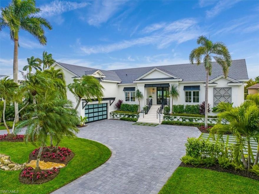 MOVE-IN READY, ENTIRELY REMODELED, WATERFRONT BEAUTY IN AQUALANE SHORES! This elevated coastal chic boaters’ paradise exudes casual elegance and benefits from a 10' Elevation and no interior flooding from recent storms! Every detail was considered in the complete ‘back-to-the studs’ stylish, high-quality redesign and update of the interior and exterior features of this outstanding waterfront property which has been entirely reimagined from its original style and 'lives like new construction'. Coveted Southern exposure and 100’ of waterfront, complete with boat dock, 16,000 lb boat lift and direct gulf access, plus an expansive remodeled pool and deck, outdoor bar, new circular driveway, new roof, new hurricane impact windows, and a new, never-used whole-home generator using natural gas. The home offers spacious covered lanais, perfect for relaxing, outdoor dining and entertaining. The interior upgrade list is extensive, featuring wide-plank European Oak hardwood floors, two kitchen islands, gleaming quartz countertops, a Wolf gas range, Miele appliances plus additional refrigerated drawers, and a 240 bottle temperature controlled wine wall in the elegant living room. The first-floor primary suite enjoys an attached sitting room with water views. Also on the first floor is a tranquil guest suite plus the optional 5th bedroom which can be used as an office or ‘flex’ room. The second level offers two more peaceful guest suites. The spacious air-conditioned 2-car garage provides additional storage for a 3rd car, jet-skis, paddle boards and bikes. Located in walking or biking distance to white sand beaches, sophisticated shopping and dining on 3rd St S and 5th Ave S.