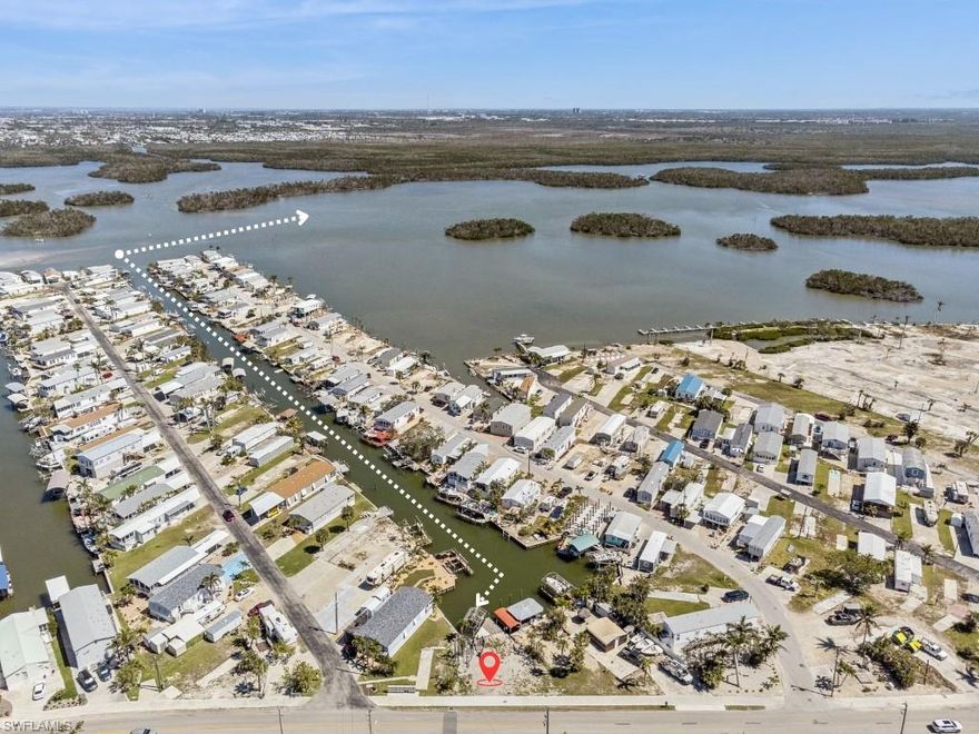 SELLER FINANCING AVAILABLE WITH JUST 10% DOWN!  Direct Gulf-access lot with dock and lift in place.  Located at the end of the canal on San Carlos Island, this waterfront lot offers a unique view out toward the bay.  With a private dock, a 10,000 lb boat lift (condition unknown) and no bridges to open water, this is an ideal setup for boaters seeking quick Gulf access.  Whether you're planning a seasonal retreat or year-round home, this lot offers flexibility and convenience just over the bridge from Fort Myers Beach.  Walk or take a golf cart to local favorites like Doc Ford's, Dixie Fish Company, and the Key West Express.  Situated in a relaxed boating community with low HOA fees, where you own the land.  Utilities available at the street.  The lot faces Main Street, sits directly on the water, and offers easy access by both land and boat.  Buyer to verify building options, permitted uses, and boat lift condition.