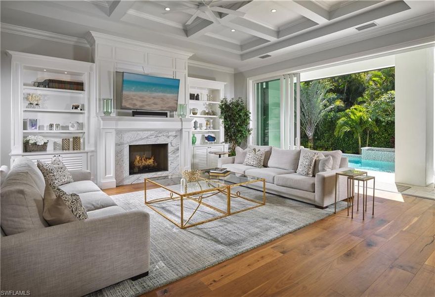 Coastal contemporary design and clean lines define this beautiful British West Indies-style home. Showcasing meticulous attention to detail, this sophisticated residence features volume ceilings, custom woodwork and hardwood floors throughout. Perfect for gourmet meals, the light and bright kitchen includes an island and walk-in pantry. A luxurious master suite, second master suite and a spacious great room with fireplace are found on the main floor. Ten-foot sliding glass doors invite the outdoors in and open up to a tropical oasis with sparkling pool, fountain and spa. Ideal for guests, the private upstairs offers three en-suite bedrooms, family room and wet bar. Owners will enjoy the close proximity to Park Shore beach access and The Village at Venetian Bay. As a Park Shore resident, voluntary membership to the private Park Shore Association is available.