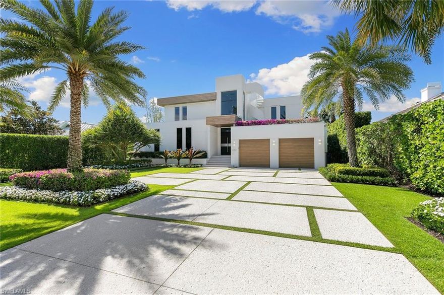 A striking custom contemporary residence ideally positioned in one of downtown Naples’ most sought-after neighborhoods, just a short stroll to the beach and the new Four Seasons Naples Beach Resort. Set on an expansive and private 0.30-acre west facing homesite and built 3 feet above FEMA’s current level with no water close to property or a garage level during any hurricane. This exceptional pool home offers the rare combination of architectural presence, refined interiors, fine craftsmanship with extraordinary attention to details, luxury finishes in a premier coastal location in the very heart of Naples. Built in 2013 and designer renovated in 2023, the home offers 3,843 SF under air and 7,576 total, featured in "Florida Design" and “Gulf Shore Life” design magazines, the home welcomes you through an inviting double door entrance and foyer with 22ft soaring ceilings. Thoughtfully designed for both elegant entertaining and everyday living, the main level features a private study with custom built-in cabinetry, a spacious primary suite with a spa-inspired bathroom including a soaking tub, separate shower, a generous walk-in closet, and a conveniently located laundry room. Sliding glass doors lead to an open sitting area overlooking the private garden and 50 foot double infinity edge pool. The light-filled great room is the centerpiece of the home, showcasing dramatic 18ft ceiling height, a linear double-sided fireplace and a stunning a floor to ceiling wall of glass that frames views of the private oversized backyard, pool and decks. Adjacent is the dining area and a chef’s gourmet kitchen featuring luxury appliances, oversized island with quartz countertops, and imported custom cabinetry, all with picturesque pool and garden views. Sliding glass doors open to a covered lanai designed for year-round enjoyment, complete with a linear fireplace, outdoor television brand new outdoor kitchen and grill, electric screened enclosure with surrounding lounge decks and pool that creates a serene and private outdoor retreat, ideal for entertaining or relaxing in true coastal style. The second level presents two generously sized en-suite guest bedrooms, a second-floor laundry, and access, via a sculptural feature spiral staircase, to an open rooftop deck—an extraordinary vantage point to entertain and enjoy sweeping city and Gulf views with exceptional sunsets over the Gulf. Additional highlights include a two-car garage, a custom grass paver driveway and beautiful landscaping. Ideally located just minutes from Fifth Avenue South’s renowned fine dining, boutique shopping, galleries, and cultural venues, this exceptional residence reflects the very best of Naples sophisticated coastal lifestyle. Never previously offered to the market, this represents a one-off opportunity to own this exceptional designer residence.