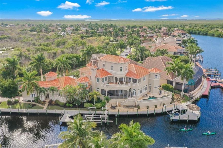 Spectacular Custom Estate in prestigious yachting community of Cape Harbour. Situated on 300' of waterfront, can fit multiple yachts- 36,000 & 15,000 lb lifts. Soaring ceilings with open floor plan; the main residence boasts gourmet kitchen; three story 3-tiered chandelier over the Formal Dining Room and Master Bath with 6 person spa are just a few features that make this home spectacular. Decorated by a world renowned interior designer; offered completely furnished and includes all art, furniture and electronics. Hardwood and marble flooring w/mosaic wall and ceiling accents gives amazing texture and feel to this estate. The adjoining 2 story Guest home or Care Taker/ Mother Law House. Walk out onto your private 4th floor veranda for unending water views of the barrier islands and the Gulf of Mexico. 2 garages. Currently 5 car spaces but possible 8. One Garage is 42’ and can accommodate RV/ Boat or 2 car-lifts that each hold 3 cars for total 6 cars in one garage. Constructed to commercial standards including concrete floors, steel beams, impact resistant windows and fire suppression system.