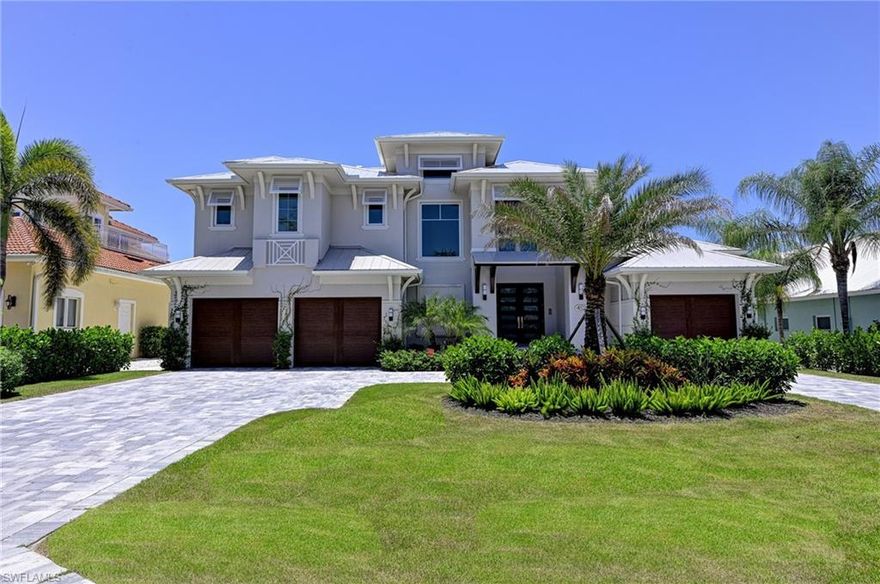 2018 waterfront home available in Conners Vanderbilt Beach. All current hurricane impact codes, this 2-story canal home includes four bedrooms, plus den, five full baths, two half baths, and three car garage. Den can also be converted to a fifth bedroom.  Amenities include saltwater swimming pool and spa, convenient pool bath, outdoor kitchen with gas grill and fireplace, electric screens and shutters, tankless water heaters, 500 gallon buried propane tank, wide plank wood flooring, gorgeous wood lined ceilings and accent beams.  The master suite is on the main living level and offers a spacious bathroom with dual vanities, freestanding soaking tub with marble surround, walk through shower, and marble flooring.  The stunning gourmet kitchen includes quartzite countertops, custom cabinetry with hidden pantry, Thermador gas range, large island with breakfast bar, and wine cooler. Elevator shaft already in place for future addition.  Covered boat dock with lift is included and offers direct Gulf of Mexico access! Conveniently located to upscale shopping and the areas finest restaurants.  Fantastic home!