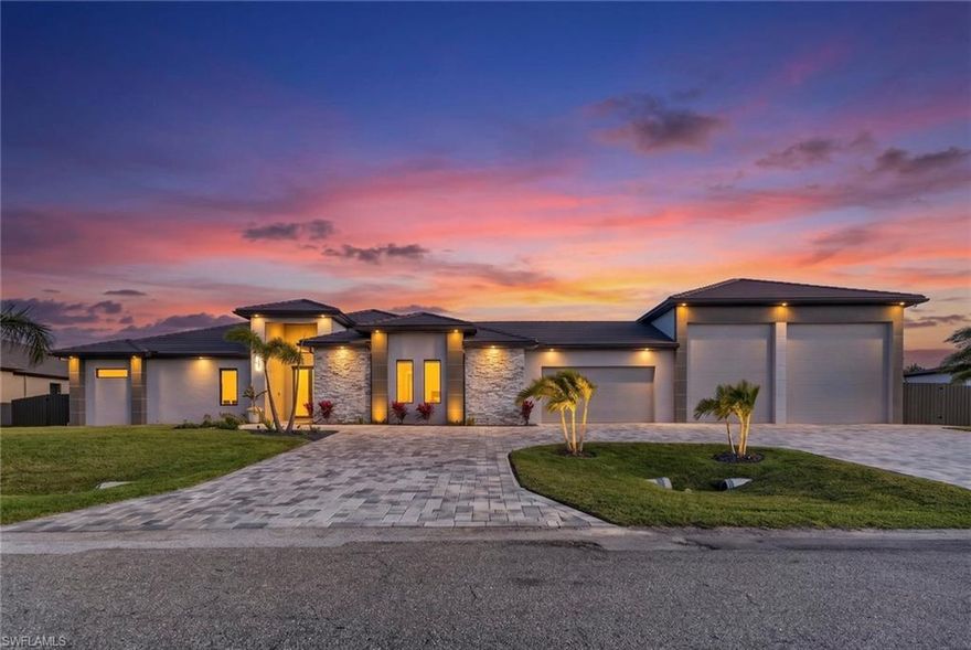 Custom-built luxury home on the Water with Gulf access, featuring a massive 2-RV garage, measuring 65' L x 30 ' W, making it ideal for RV owners, boat storage and car enthusiasts. This garage can fit one RV, plus 1 36' boat, or 1 boat and 5 cars. Built in 2024, the home provides 3,500 square feet under air with 4 bedrooms, an office, a home theater and 6 baths. The property includes a private newly constructed grey composite dock with a large canopy, a custom fish cleaning table, and a heavy-duty boat lift up to 36 feet. One of the home's most desirable features is a huge 23' x 17' home theater with a high-quality surround sound system, screen projector, bar with quartz countertop, mini fridge, microwave, custom European cabinets and 2 big closets with shelves. A panoramic picture-window screen enclosure maximizes canal views without visual obstruction. The kitchen offers quartzite countertops with a waterfall island, a huge walk- in pantry with shelves, custom cabinetry, high-end fixtures and several closets throughout the home. High-quality, large porcelain tile  throughout all bathrooms. Wired speakers (two inside and 3 outside) provide an integrated entertainment experience. Wire security cameras all around home, Situated on an oversized .0.48-acre, Gulf access canal lot, this remarkable residence offers a total of 6,542 square feet under roof. The stunning outdoor living area includes a HUGE swimming pool around 50' L x 16'w with heated pool and spa, outdoor shower with cold/hot water, travertine deck, irrigation system, exterior lighting, and covered lanai, also features are new remote-control hurricane shutters. The expansive lanai along with a full outdoor kitchen, equipped with gas stove, extractor hood, ice maker and beer machine, refrigerator, double oven and two mounted televisions. whole-house reverse osmosis RO system, 6 fans with remote control, Kids Park area with turf and powerful solar lights This property combines, unique modern design, quality construction, and a prime waterfront setting to deliver a refined and distinctive waterfront living experience Minutes to Coral Oaks and Royal Tee golf courses, Publix, and the future 7 Islands waterfront dining and shopping district. Impact doors and windows, grey tile roof showings for SERIOUS buyers only!