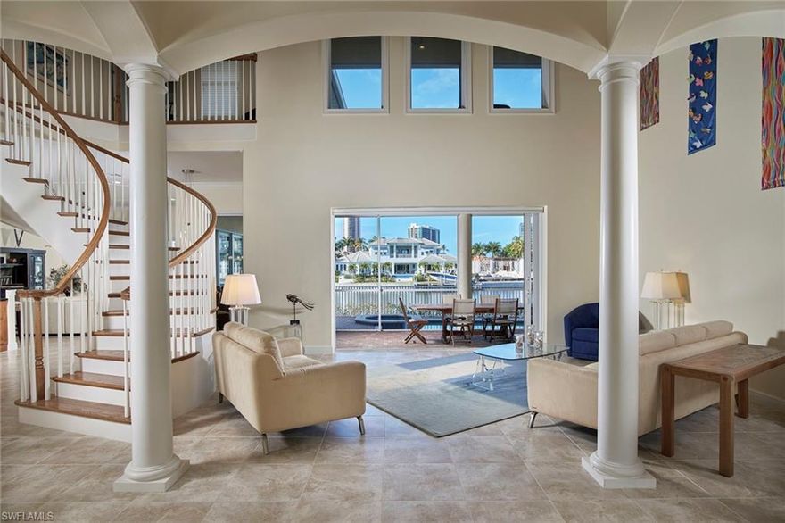 Delight in panoramic water views from numerous vantage points in this palatial Park Shore home. The spacious interior includes six bedrooms, a study and morning room, a screened second-floor balcony and a stunning open living room space in the center of the home. The sprawling first level with copious amounts of glass allows for an abundance of natural light and sunsets from nearly every room. The open kitchen concept is the ideal setting to entertain family and friends while the 4-car garage and spacious driveway allow for plenty of company to join. If spending time in or on the water is more your thing, this location has you covered. Complete with a pool, spa and dock, this home is the perfect choice for an active family: boating, jet skiing, kayaking and/or paddleboarding are all options from your very own backyard. When the day is done and it is time to relax, position yourself indoors or out in a comfy lounge chair and watch a palette of vivid colors paint the early evening sky to the west.