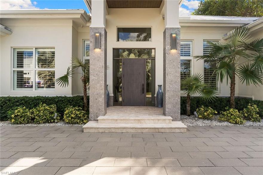 This exquisite 2020 custom-built residence in the heart of Coquina Sands offers 3,730 square feet of thoughtfully designed living space, blending modern elegance with timeless comfort. In one of Naples desired central locations, this home is just a few blocks from the beach, minutes to the new Four Seasons Resort, and moments from fine dining and shops of 5th Avenue South. The home features four spacious en-suite bedrooms plus a den, all centered around an open-concept floor plan that welcomes abundant natural light and effortless flow. Soaring 12-foot ceilings elevate every living space, from the family room to the formal sitting area, separated by a stunning glass-enclosed, temperature-controlled 80-bottle wine cellar. An entertainer’s kitchen offers a double gas range, dual ovens and a hidden butler’s kitchen for seamless hosting. Custom millwork, built-ins and walk-in closets enhance the home’s refined design, while the primary suite serves as a serene retreat with dual vanities and a large walk-in shower. The outdoor living space is equally impressive, featuring a covered lanai with gas grill and sink, a cozy fireplace and a luxurious custom spa. With desired southern exposure, the backyard enjoys sunlight all day, creating a private oasis in the heart of Naples.