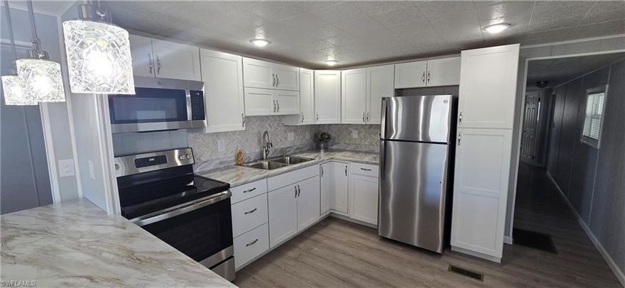 Light and Bright! New fully updated interior on this beautiful home in Imperial Harbor. Imperial Harbor is a 55+ community in a wonderful location, close to downtown Bonita Springs, award winning dining and shopping, and beaches. The new remodel includes vinyl plank flooring, stainless appliances, new countertops with gorgeous tile backsplash, full paint and new fixtures.