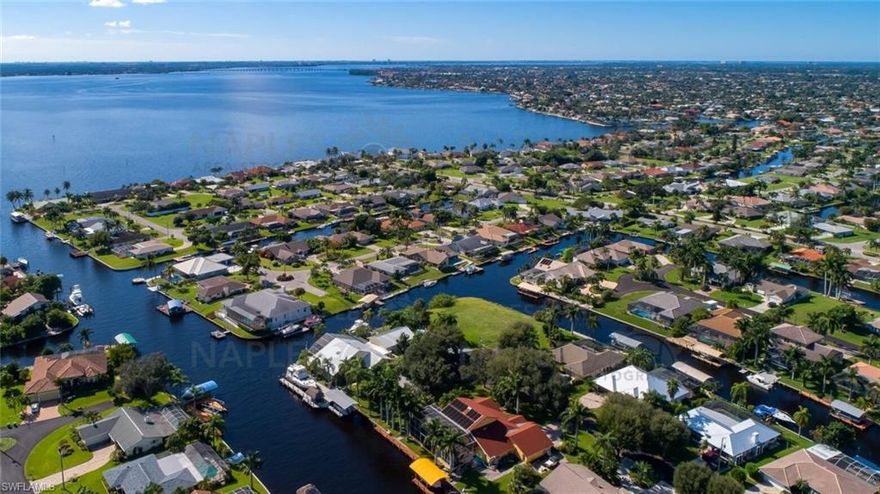 LOCATION, LOCATION, LOCATION! Large furnished Gulf Access pool home. Fantastic boating location with quick out and no bridges limiting the height of your boat. This area is the highly sought after Cape Coral Yacht Club area, known for its deep canals and close proximity to the vibrant entertainment area of downtown Cape Coral. It is a very active area with many restaurants, bars, festivals, and a large farmers market. Walkable and great bicycling. Easy access to the attractive downtown Fort Myers (8 miles) and the beaches of Fort Myers Beach (6 miles).                                                                                                                                                               VALUE! This area has many multi-million-dollar homes. The empty lots in this area have sold for a range of $475,000 to over $1,000,000. Replacement cost to build a home this size exceeds $700,000 ($320 per square foot) plus the lot cost.                                                                                                                              THE HOME! 818 Monticello Ct features 2180 Square feet, larger than most in this area. With a 2018 roof, a 2025 HVAC System, this home has had important updates. It has a highly sought after floorplan featuring a split bedroom layout with the main bedroom at opposite ends of the home from the guest bedrooms. There is a critical pool bath that doubles as the guest bath that services the pool and canal front area with no need to walk thru the home keeping those happy wet feet outside! The kitchen, family room, dining room, main bedroom, and 1 guest bedroom open to the pool, dock, and canal. This is the most popular layout available. The heart of this home is the kitchen and dining room with direct access to the kidney shaped pool, dock and canal. The sliding patio doors leading to the pool deck slide into the walls, creating an unobstructed view. The main bedroom has a double sink vanity in the bath, a large walk-in shower and nice closet space. The guest wing features two spacious guest rooms, a large indoor laundry/utility room, and excellent storage. This home is a successful vacation rental, offsetting the cost of ownership.
