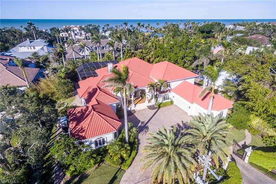 Perfectly situated on over a half acre on Gordon Drive in Olde Naples and one block to the beach access walkway. This lovely traditional home features an exceptional outdoor entertainment space, with pool, spa, water features, outdoor kitchen and bar is buffered by lush landscaping. Over 6,000 square feet offers five bedrooms, six bathrooms, open kitchen, family room, loft space, formal living and dining rooms, wine storage and an air-conditioned five-car garage accessed by a gated circular driveway. You'll enjoy the short distance to the shops and restaurants of Third Street South and the close proximity to the Naples Pier.