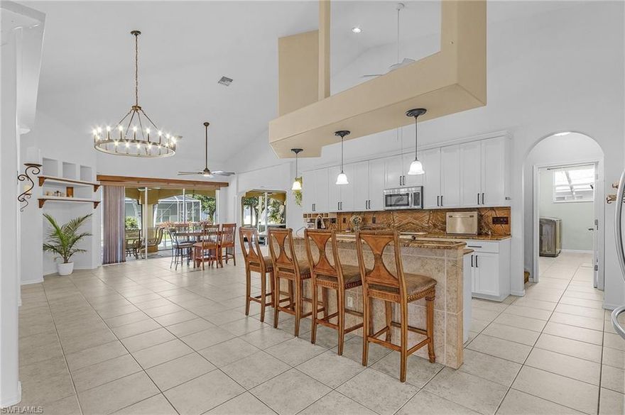 AMAZING NEW PRICE! Cape Harbour Marina Neighborhood without the HOA restrictions. This property boasts over 3042 square feet of FABULOUS living space! It features 3 bedrooms on the main level with two bathrooms, one bedroom has an ensuite pool bath. The kitchen has marble countertops and a large breakfast bar with dining area that will seat the whole family. Induction stove with all stainless steel appliances. There is a plethora of storage throught the entire home. There is no lack of spaciousness for entertaining or just living with excellent separation of space. Turn the other half of the main kitchen area into a living room and also enjoy a huge family room around the corner! It is currently setup as a dining space in the kitchen. The office is set up with great built ins for all your personal and business needs. Potentially 5 BEDROOMS! The extra-large flex room can be used as another living area, game room, media room, or homeschooling room – so many ideas to choose from!  Heading upstairs to the spacious master suite is a very inviting place to get away from it all.  The primary bath features dual vanities, soaker tub, and walk-through shower. The surprise is a laundry drop shoot right into the in-residence laundry on the first floor. The west facing screened in lanai is a wonderful oasis with a hot tub to relax in. The open pool area with outdoor seating is great for afternoon family gatherings, BBQ dinners, and parties with neighbors and friends. The neighborhood is extremely sought after and filled with million dollar plus homes all around. New Roof 2021. Reverse Osmosis System For Drinking Water. New A/C 2025 and Other Is 2019. 9 Foot Elevation, Zero Flooding. No Assessments Owed. Electric Pool Heater 2020.