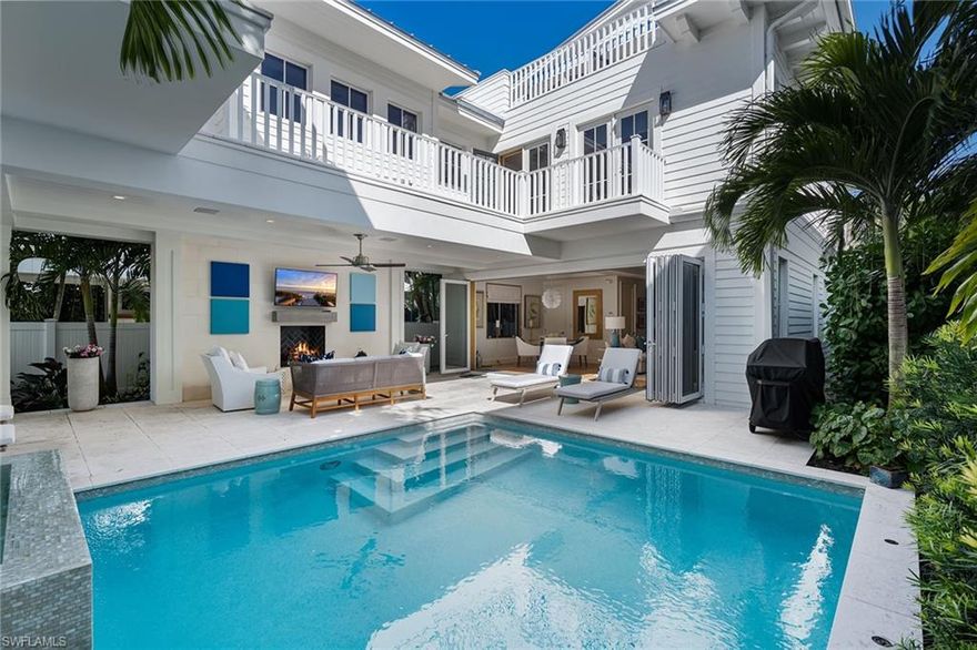 With an idyllic Old Naples location, this 2017-built “Poinciana Cottage" is available for immediate occupancy. Set along a tree-lined street steps from the beach, stylish boutique shops, art galleries and a wide array of restaurants in the shopping district along 5th Avenue South. This thoughtfully designed home offers beautiful interiors with a newly renovated kitchen adorning Ruffino Cabinetry & Wolf/Sub-Zero appliances. The main level offers a generous living area with separate dining spaces overlooking the pool/spa out to the covered outdoor lanai with a cozy fireplace setting. The spacious master suite, 3 guest suites, den and rooftop deck located on the 2nd and 3rd levels can be accessed via stairs or a glass elevator. There is a 2-car garage via the alley access with extra parking. A wonderful opportunity to live in the heart of Old Naples.