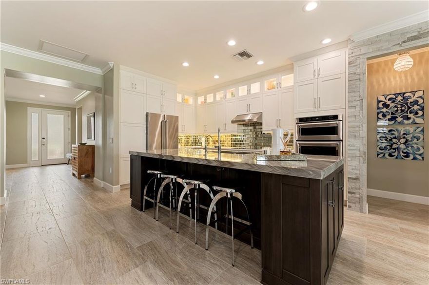 This beautifully remodeled first-generation Tifton home showcases thoughtful design, premium upgrades, and modern efficiency throughout.  Expansive 18” X 36” tile throughout creates a cohesive, open feel and simplifies furniture placement. Triple windows in both the owner’s suite and dining room, along with larger sliders, flood the home with natural light. The front entry makes a striking impression with a rain glass entry door providing both light and privacy. 
Inside, recessed LED lighting brightens all the rooms. Crown moulding throughout, and plantation shutters along with a neutral paint palette create the perfect backdrop for the beautiful interior furnishings. 
The gourmet kitchen is designed for both beauty and function, featuring upgraded stainless-steel appliances including an induction cooktop with a range hood vented directly outside, wall oven, convection microwave and a very quiet dishwasher. Blanco granite composite sink with air switch disposal, retractable outlets, and soft-close cabinetry and pantry pull-outs elevate everyday cooking. Lower cabinets include pullouts and drawers for easy access, while the oversized island offers additional small-appliance storage on both ends. Custom rain-glass light-front boxes with above-cabinet lighting and under-cabinet lighting complete the space.
The den is a standout feature, offering 8-foot rain-glass pocket doors that preserve foyer space, pre-finished hardwood flooring, recessed lights, and built-in storage cabinets—ideal for a home office or flex space. Both the owner’s bedroom and secondary bedroom include recessed reading lights, while custom window treatments are featured throughout the home.
The owner’s suite is a private retreat with triple windows, custom window treatments, a Burns trim accent wall, and elegant sconce lighting at the nightstands. The spa-inspired owner’s bath includes a pocket entry door, a large walk-in shower with rain head, body sprays, and a separate handheld shower, plus an impact-glass window within the shower. The private water-saving commode and a fully customized walk-in closet complete the space. The secondary bath features a water-efficient commode, and a rain-head shower with a separate handheld.
Additional highlights include closet organizers in every closet, a well-appointed laundry room with utility sink, upper and lower cabinets, under-cabinet lighting, and an LG washer and dryer. The home also features a whole-house water softener, reverse osmosis at the kitchen sink and refrigerator (including ice maker and water dispenser), and a Wi-Fi-enabled water heater. A new air-conditioning system was installed in 2025.
The garage is finished with an epoxy floor, storage cabinets, and a refrigerator, while floored attic storage adds valuable extra space. Every detail of this home reflects quality, comfort, and modern living—truly a move-in-ready property designed to impress.