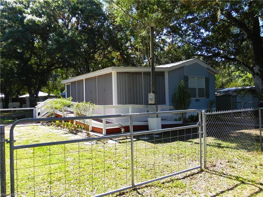 GREAT FIND IN LABELLE!!! Picture yourself sitting in the large, screened-in lanai enjoying your morning coffee or 
entertaining family & friends!! This home features an over sized lanai perfect for anytime of the year due to the large mature shade trees!! This is 2 bedroom / 2 bath home in good condition. The open concept of the home and the split bedrooms provide the perfect living space!! The well-maintained property boast two outbuildings (one has water & electricity for full size washer & dryer) and is completely fenced!! Hurry this amazing find won't last long!!