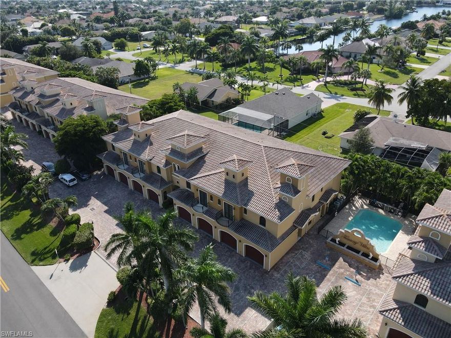 AMAZING LOCATION, so close to the best of SouthWest Cape. This LARGE second floor condo lives like a single family home complete with a single car garage and is situated right next to the community pool. Over 1700+ sq ft of open floor plan offers vaulted ceilings and lots of natural light to brighten this home. The well designed kitchen with tons of counter space, oak cabinets and a pantry makes cooking a joy, especially when using the new stove and fridge. Split bedrooms, a large living and dining area with access to the screened lanai offer plenty of space. The master bedroom has tray ceiling details, access to the screened lanai, walk in closet and an ample master bath with walk in shower and dual sinks. Guest bedroom has adjoining bath and is next to the large Den with balcony access. Add in the half bath, in residence laundry with newer washer, lots of storage space, updated carpeting and paint, a newer hot water heater and private views off the lanai makes this perfect place to call home! Tuscany Villas is a well maintained community with lush landscaping, two pools and pavered drives.