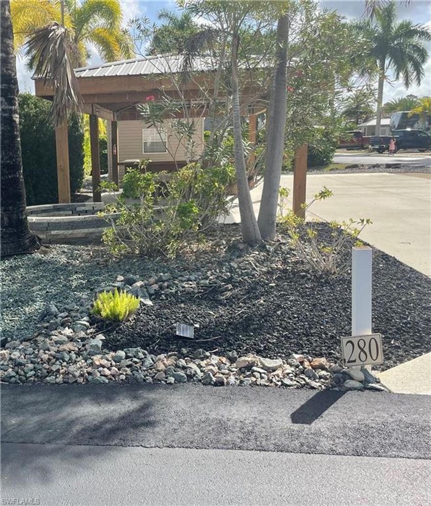 Welcome to lot 280 located at Cypress Trail Resort Cir, Fort Myers.  This lot is a double lot (approximately 60x90') with a 12 x 24' (approx.) metal-roofed pavilion. The roof is hurricane-strapped, and uprights are set in deep concrete footings. The lot is paved with concrete and stone. French drains surround the concrete, and there is a drain linkage for RV runoff to the French drains.  The mature landscaping on this lot includes gardening rocks, a lemon and lime tree, a banana tree, and plenty of palm trees. The landscape includes an irrigation system. Electricity is run throughout the pavilion and to the roughed in kitchen. The roughed-in outdoor kitchen has electricity, running water, and space for a water heater and refrigerator.  This excellent sun exposure  lot is close to the main center of the resort and the lake, and only a walking distance to the pool & clubhouse. Your RV will perfectly shade the lot in the afternoon, and the pavilion provides plenty of shaded area for the rest of the day. The shed is unfinished but could be finished to your own design. It has electricity and breakers to control the pavilion electricity. Contents of the shed include extra pressure-treated landscaping wood, a small water heater, and an outdoor table and chairs. Contents are included in the sale. This beautiful RV lot is located within the 5-star-rated resort in Fort Myers East off I-75.  This resort gives you quick access to all of southwest Florida's gorgeous beaches, in addition to Fort Myers Beach and Sanibel Island.