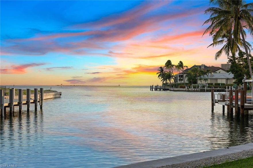 This extraordinary Polynesian-inspired residence, in the prestigious Estates of Marco Island on the island’s desired street, Caxambas Court, represents the pinnacle of coastal living. With 112 feet of waterfront, direct and quick Gulf boating access, and sweeping water views, it captures the essence of the island lifestyle. Set on over half an acre with desirable southern exposure, the home is framed by lush tropical landscaping and welcomes guests with a grand double-door entry and an oversized circular driveway, creating a private and inviting retreat. The split-bedroom floor plan includes three bedrooms, two-and-a-half baths, a den and a three-car garage. Inside, vaulted ceilings, plantation shutters, recessed lighting and expansive windows fill the open living spaces with natural light. The chef’s kitchen is stylish and functional, offering abundant cabinetry, a center island with an electric cooktop, a breakfast counter illuminated by pendant lighting, and a charming built-in bench nook. A large pass-through window above the sink ideally frames the long and wide water views. Pocket sliders open to the dining area and great room, where a fireplace, wet bar, and panoramic vistas create a seamless transition to the lanai for effortless indoor-outdoor living. The owner’s suite is a serene escape, accessed through double doors, and features sliders to the lanai, a cozy sitting area, and two spacious walk-in closets with mirrored hallways. The luxurious en-suite bath includes dual vanities with a makeup counter, a glass-enclosed walk-in shower, and a jetted soaking tub with tranquil tropical views. A guest bedroom used as an office features built-in cabinetry, shelving and water views, with access to an en-suite powder bath that doubles as the pool bath. The second guest bedroom sits adjacent to a skylit bath with a shower-tub combo and glass enclosure. The oversized laundry room provides exceptional functionality, with white cabinetry, a utility sink, hanging rack, built-in desk, storage closet, and GE washer and dryer. The outdoor living space is a showpiece, offering a screened lanai with a heated pool and spa, generous covered seating and dining areas, and breathtaking wide-water panoramas. The newer 2022 corrugated seawall ensures lasting strength and peace of mind. Ideally in the Estates neighborhood, this home provides easy access to award-winning beaches, waterfront dining, boutique shopping, golf, tennis, pickleball, kayaking and cultural attractions such as Marco Island Historical Museum, art center and theater. Close to quality schools and the executive airport, this residence embodies the ultimate in refined island living. The possibilities are endless!