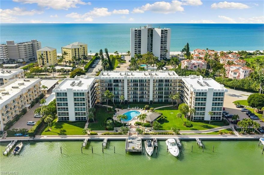 Welcome to Venetian Cove Club, where coastal elegance meets an exceptional lifestyle. This remodeled bayfront residence offers over 1,000 square feet of refined living with two bedrooms and two baths. The west-facing balcony provides sweeping Gulf views and stunning sunsets, while east-facing windows capture sunrise vistas over the bay and sunlight over the pool and marina. Inside, the spacious layout features new wood flooring throughout and custom electric interior shades that optimize lighting, privacy, and energy efficiency. The modern kitchen showcases large countertops, updated appliances, ample storage, island seating, and a window over the sink overlooking the bay, boating area, and pool. The open-concept living and dining space allows for seamless entertaining. The primary bedroom offers impact glass, direct access to the balcony, and beach views just across the street. The second bedroom also features balcony walk-out access with Gulf views. The residence includes walk-in closets and an in-unit laundry area for added convenience. Venetian Cove Club is a low-density condominium community comprised of approximately 60 residences directly on Inner Doctors Bay, just steps from the sugar-white sands of the Gulf of Mexico. Residents enjoy a bayfront pool with sundeck, barbecue and grilling areas, community lounge spaces, bike storage, and boat slip and kayak storage available for lease. The pool deck and seating areas overlook the water, creating social and entertaining spaces overlooking Venetian Bay. The association provides structured parking, on-site management, and elevator access. Optional membership in the adjacent Park Shore Beach Club enhances private beach access and enriched coastal living. This west of U.S. 41 location places you within walking or biking distance to the fine dining and luxury boutiques of Venetian Village, as well as scenic Naples Bay frontage and world-class Gulf beaches. With strong rental potential and direct beach and boating access, this residence is ideal for buyers seeking both lifestyle and investment appeal. Residents can enjoy boating with a short ride to the Gulf or a leisurely cruise through Naples Bay lined with multimillion-dollar estates.