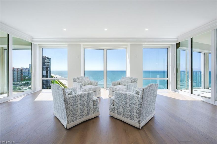 A rare offering at The Enclave, where prestigious beachfront living has been reimagined, this just completed 2025 renovation showcases panoramic views of the Gulf, Bay, and city skyline and epitomizes modern coastal sophistication. Spanning over 6,300 square feet under air, the 4-bedroom plus den residence with a bonus room features herringbone wood flooring, Calacatta Gold quartz surfaces, and bespoke designer finishes throughout. The gourmet kitchen, featuring Miele appliances and dual Sub Zero refrigerators, serves as a stunning centerpiece for entertaining, complemented by open living spaces with a welcoming fireplace and a dining area with a wet bar complete with a Miele wine cooler and dual beverage drawers, perfect for gathering with family and friends. This unit includes an oversized 2-plus car garage. There are two lanais, one off the primary bedroom and a larger lanai off the living room and dining room, which features 180-degree north and south views from the building’s first position on the beach. The larger lanai includes an outdoor kitchen setup, prewired and preplumbed for convenience, new glass railings, and the perfect vantage point for Gulf breezes and sunsets. Each guest suite is spacious and en suite with ample closet space. Additional features include a secure private elevator opening directly into the residence, gated entry, a den or home office with fireplace, zoned HVAC, electric hurricane shutters, and generous storage. Custom furnishings in luxurious fabrics and trims add to the residence’s curated elegance, resulting in a timeless and refined design. The Enclave offers one of Naples’ most exclusive beachfront lifestyles, with only one residence per floor and a soon to be completed total renovation of the public areas including a state-of-the-art fitness facility, a modernized social room, and a pool renovation with new deck and pavilion. A hurricane-resistant lobby and completely redesigned entry will arguably make The Enclave the best on the beach upon completion in 2026. Residents may also lease or purchase a boat slip at the Venetian Yacht Club.