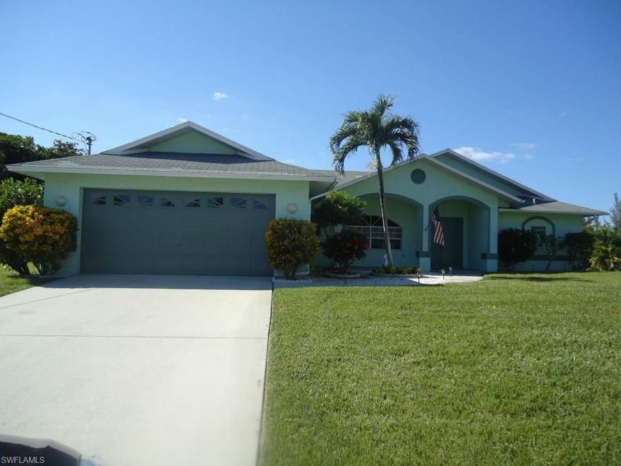 Beautifully maintained pool home across the street from waterfront homes and located in a wonderful SW Cape Coral neighborhood of newer homes. This 3 bedrooms/2 baths is built on a 3 lot site with a HUGE screened in pool deck allowing plenty of sunny and shaded areas for year round enjoyment. Formal dining room as well as a pool side dinette area.  Newer flooring in main living area.... New carpet in all bedrooms. New A/C in 2009....Newly painted inside and out....Whole house generator....Very private pool area....City water and sewer....Close to shopping, dining, boat ramp and more. This home is truly move-in ready and very easy to show.