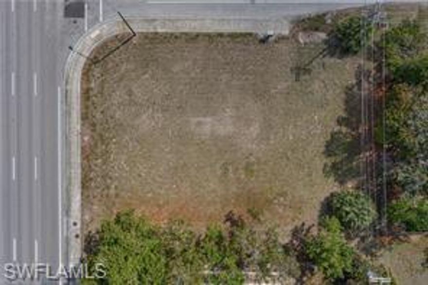 corner commercial lot on busy street, tons of exposures, close to everything, build your dream on it, fast growing town in SWFL