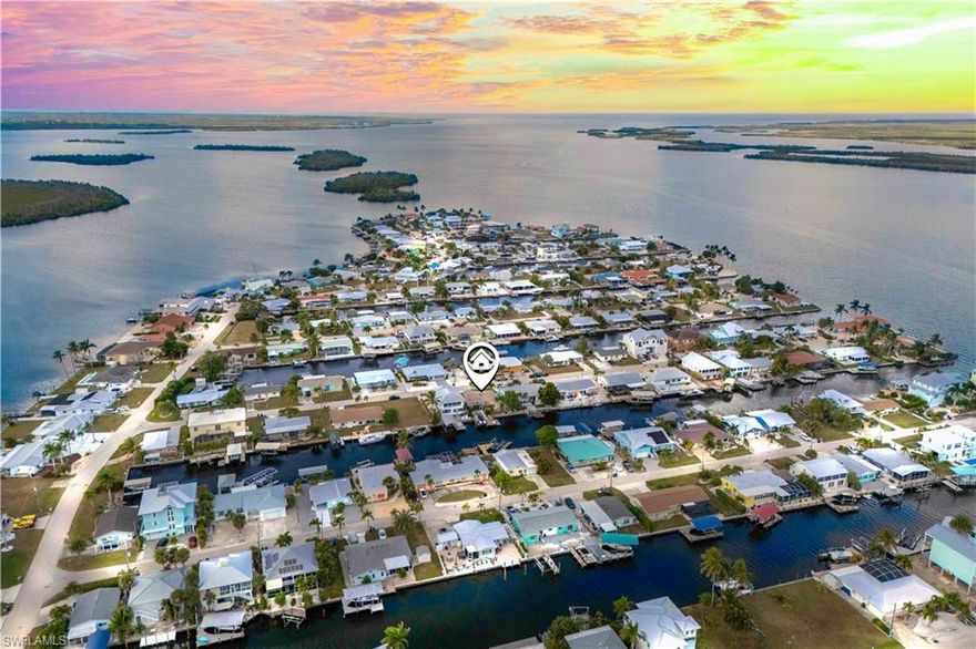 Waterfront Paradise with Direct Gulf Access and SOUTHERN EXPOSURE! Experience the ultimate Florida lifestyle at 2781 Bruce Street.  This beautifully and luxuriously updated home features TWO spacious primary suites, 3-bathroons with a sunroom and offers effortless indoor-outdoor living and PRIME Gulf-access boating with deep water access and one minute out to open waters. Fully renovated kitchen and bathrooms with modern finishes, complimented by plantation shutters throughout, combining elegance and functionality. Wake up to serene canal views, enjoy morning coffee in the sunroom flooded with natural light, and step outside to your private dock with boat lift —and an open, airy layout with large windows frames the sparkling canal and enhances the bright, welcoming interior. This home is being sold fully furnished, making it move-in ready and perfect for immediate enjoyment. Designed for those who crave both relaxation and adventure, it’s ideal for entertaining, unwinding by the water, or launching your boat directly to the Gulf in minutes. Located in a tranquil residential setting in the magical island of Matlacha and filled with olde Florida charm, stunning sunsets, with some of the best fishing right off your back yard!  Stroll over to the many shops/artist galleries just a few streets away, or enjoy the  close to local amenities, this property is perfect for boating enthusiasts, sunseekers, and anyone dreaming of a true waterfront escape.  This is more than a home — it’s a lifestyle. Your waterfront paradise awaits!