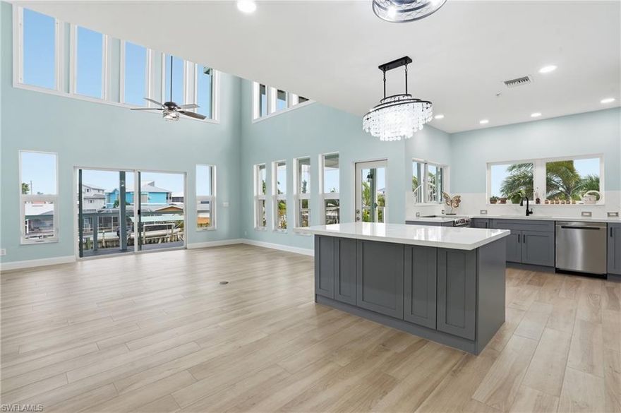 Experience the ultimate St. James City waterfront lifestyle in this beautifully updated Gulf-access pool home, featuring two boat lifts with new motors (16,000 lb and 10,000 lb) and approximately 2 minutes to the Intracoastal by boat. Enjoy peace of mind with a new 2024 roof, HardieBoard exterior siding, and all-new composite outdoor decking, including expansive wraparound decks and stunning rooftop deck space that truly elevate indoor-outdoor living. Inside, a beautifully updated kitchen opens to a light-filled living area with soaring 24-foot ceilings in the family room. The primary suite feels like a private retreat with a spa-inspired, oversized shower. For movie nights, there is a dedicated home theater, so you can catch the latest blockbuster without leaving your home. Downstairs you will find a perfect guest- friendly bonus space with kitchen and cozy living area. Outside, the property is dotted with bearing fig, banana, and dragon fruit trees, adding a unique island touch to this one-of-a-kind coastal escape.