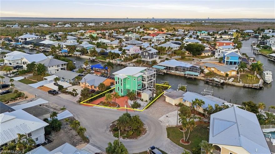 Experience the ultimate St. James City waterfront lifestyle in this beautifully updated Gulf-access pool home, featuring two boat lifts with new motors (16,000 lb and 10,000 lb) and approximately 2 minutes to the Intracoastal by boat. Enjoy peace of mind with a new 2024 roof, HardieBoard exterior siding, and all-new composite outdoor decking, including expansive wraparound decks and stunning rooftop deck space that truly elevate indoor-outdoor living. Inside, a beautifully updated kitchen opens to a light-filled living area with soaring 24-foot ceilings in the family room. The primary suite feels like a private retreat with a spa-inspired, oversized shower. For movie nights, there is a dedicated home theater, so you can catch the latest blockbuster without leaving your home. Downstairs you will find a perfect guest- friendly bonus space with kitchen and cozy living area. Outside, the property is dotted with bearing fig, banana, and dragon fruit trees, adding a unique island touch to this one-of-a-kind coastal escape.