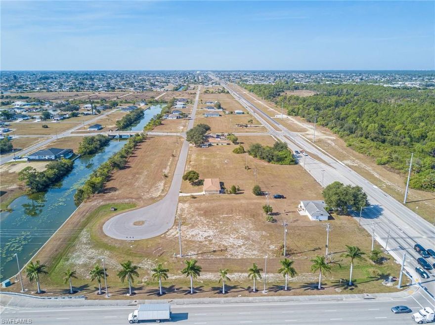 A Visionary Development on the Water. Incredible opportunity to acquire a large commercial land assembly along Kismet Pkwy E, Del Prado BLVD. N. and NE 23rd Terrace in fast-growing Northeast Cape Coral. This combined offering features multiple freshwater canal lots with access to 9 beautiful lakes, allowing future development to incorporate dockside dining, retail, professional offices, banks, and other waterfront commercial uses. Zoned commercial with excellent exposure on a busy corridor, this site offers exceptional potential for a signature commercial project. Income-producing property is currently onsite, providing immediate value while development plans are underway. There are 4 single family homes on the property also zoned commercial that generate monthly income. A rare chance to shape one of NE Cape Coral’s most exciting growth areas. City water and sewer ready to be hooked up! Realtors see confidential remarks for all parcels.