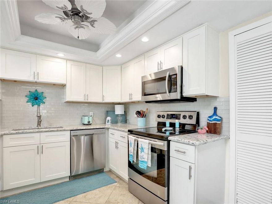 REMODELED FIRST FLOOR TURNKEY FURNISHED 2 bedroom 2 bathroom end unit condo conveniently located off the coveted Beach Pkwy in the 55+ Rendezvous community! Upgraded kitchen features newer white shaker cabinets, stainless steel appliances, granite countertops, glass tile backsplash, tray ceiling with crown molding and fan. Tile flooring can be found throughout except upgraded carpet in the bedrooms, very convenient. Recent updates include a NEW ROOF (February 2024), all new plumbing (2022), electrical panel replaced (2021), and water heater (2018). You will love the master suite with a large walk-in closet, ensuite bathroom with a new shower door (2023), new vanity with backsplash, and lighting. The guest bedroom has access to the guest bathroom which features a new vanity with backsplash and lighting. Both bedrooms offer sliders that open to a concrete patio in the backyard.  Interior upgrades include NEST thermostat, new 2-panel interior doors, and window blinds & curtains. Newer screens can be found on the screened in lanai that was recently painted in October 2024. Hurricane impact windows & sliders and hurricane pull-down shutters on the front lanai offer convenience and peace of mind. Enjoy a covered carport space and a storage closet just steps away. Relax on the front-facing lanai just steps away from the heated community pool. Centrally located between the Midpoint Bridge and South Cape Coral Bridge, this location provides easy access to Fort Myers. Nearby you'll find Jaycee Park on the river, Four Freedoms Park, and Cape Coral Yacht Club. Just 30 minutes to RSW International Airport. Don't miss the opportunity to own this beautifully UPDATED condo in a prime location!